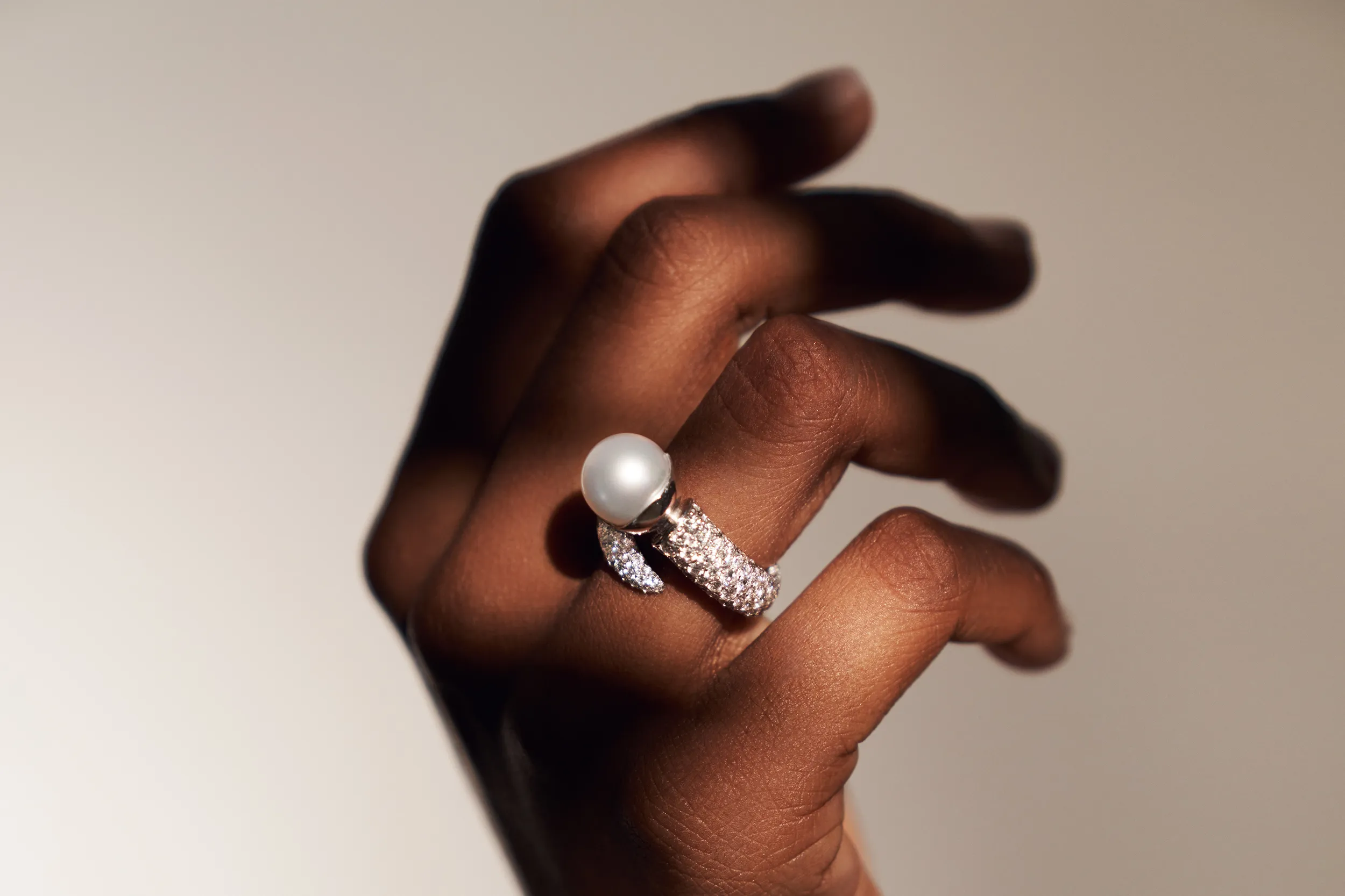A model wears the El'eeté Jewellery South Sea pearl ring from Collection №1 with 300 brilliant-cut white diamonds totalling 3.9 carats and an 11mm pearls set in 18k white gold 