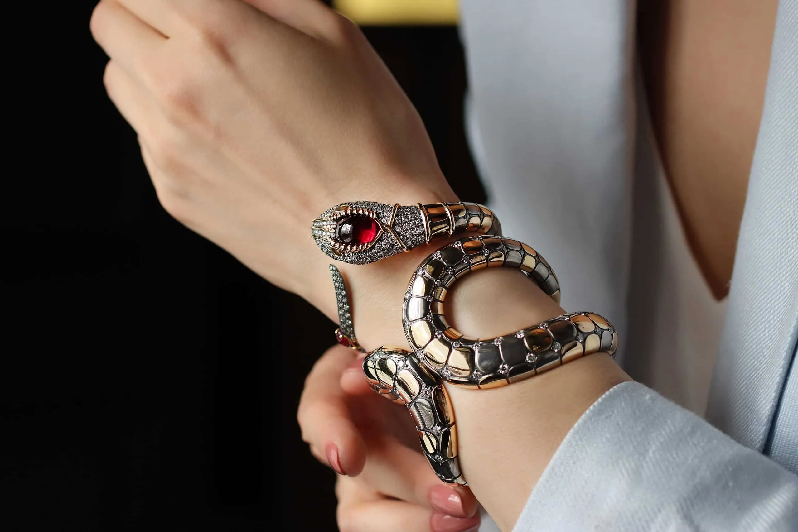 Elie Top Snake cuff bracelet from the Magica Naturae collection with a cabochon rubellite in yellow gold and silver