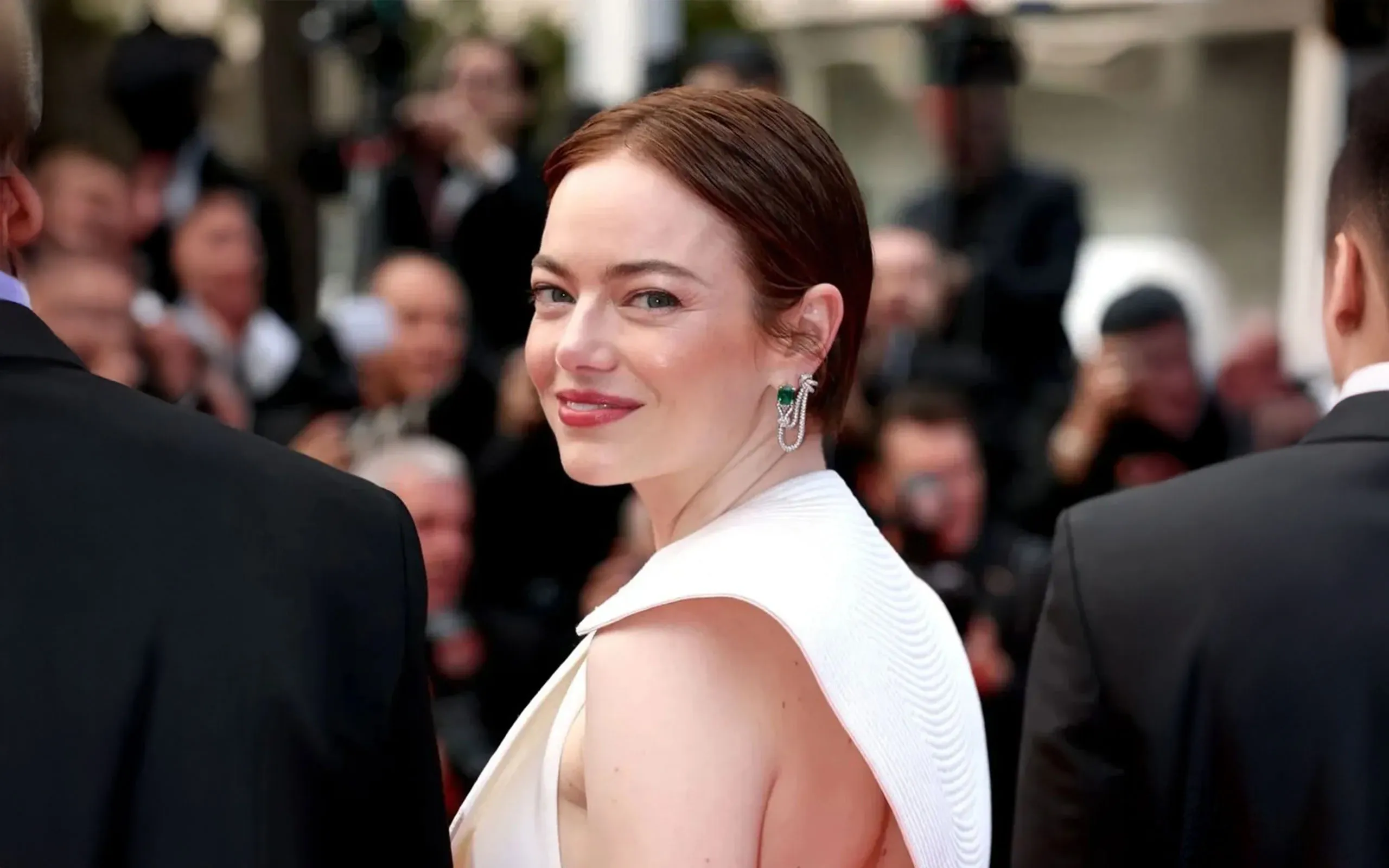 Actress Emma Stone wears the Louis Vuitton Seduction earrings with octagonal-shaped emeralds to the Cannes Film Festival 2025