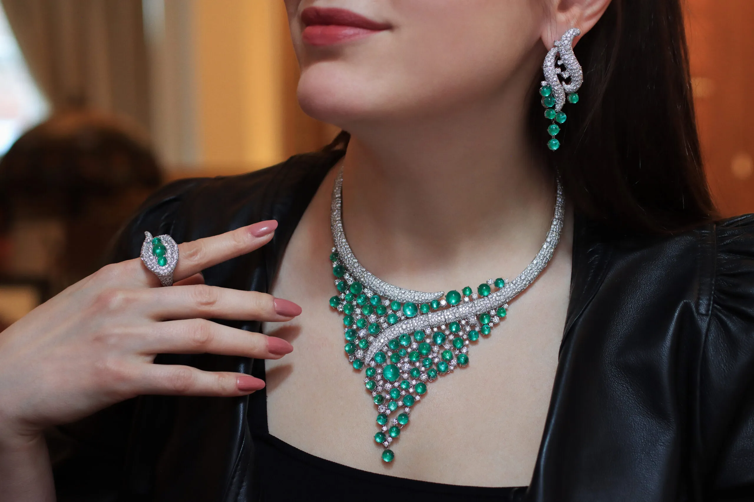 Katerina Perez wears the AKANO Mkpulu suite including a necklace, earrings and a matching ring with diamonds and emeralds in 18k gold 