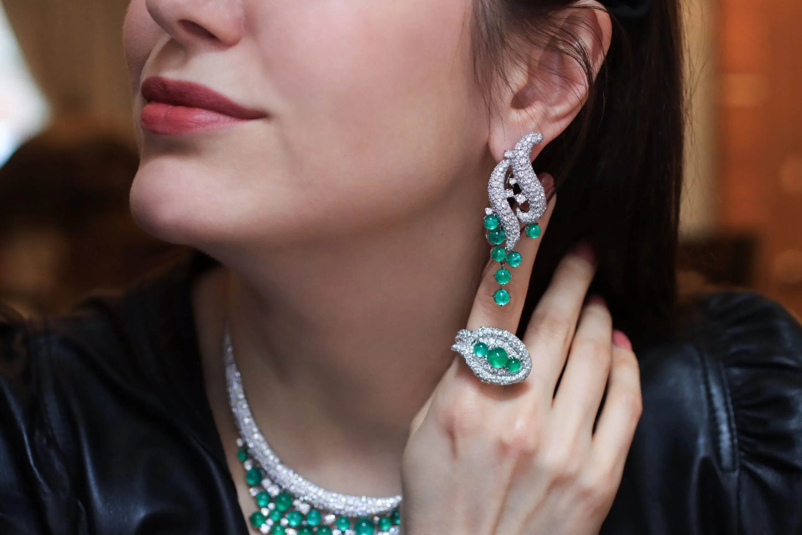 A closer look at the AKANO Mkpulu earrings with 10 carats of diamonds and 13 carats of emeralds, alongside the matching ring with further diamonds and emeralds, both in 18k gold