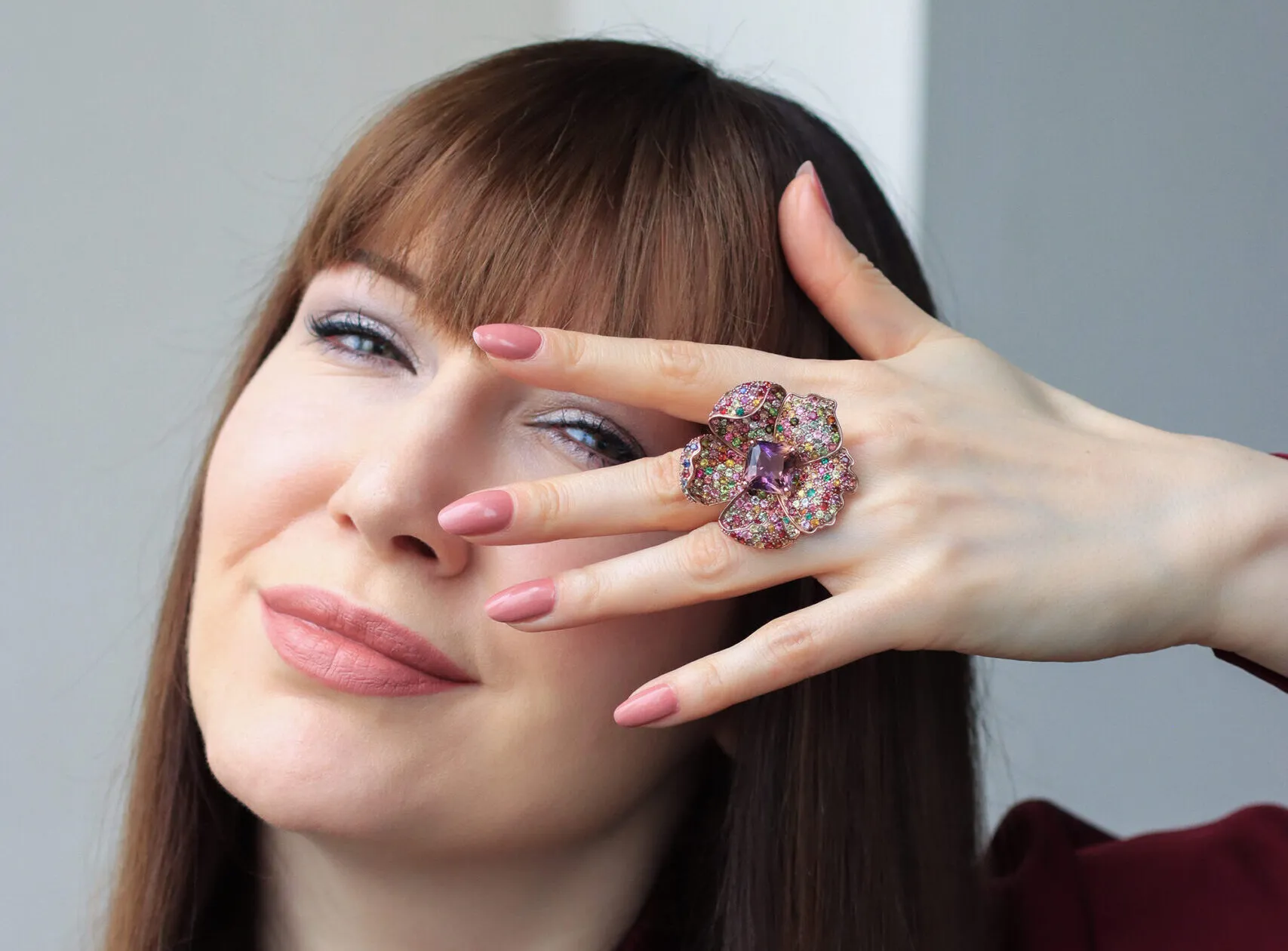 Katerina Perez wears the Amethra ring by Zome Jewellery set with a large ametrine centre stone surrounded by multi-colour sapphires and tourmalines in 18k rose gold 