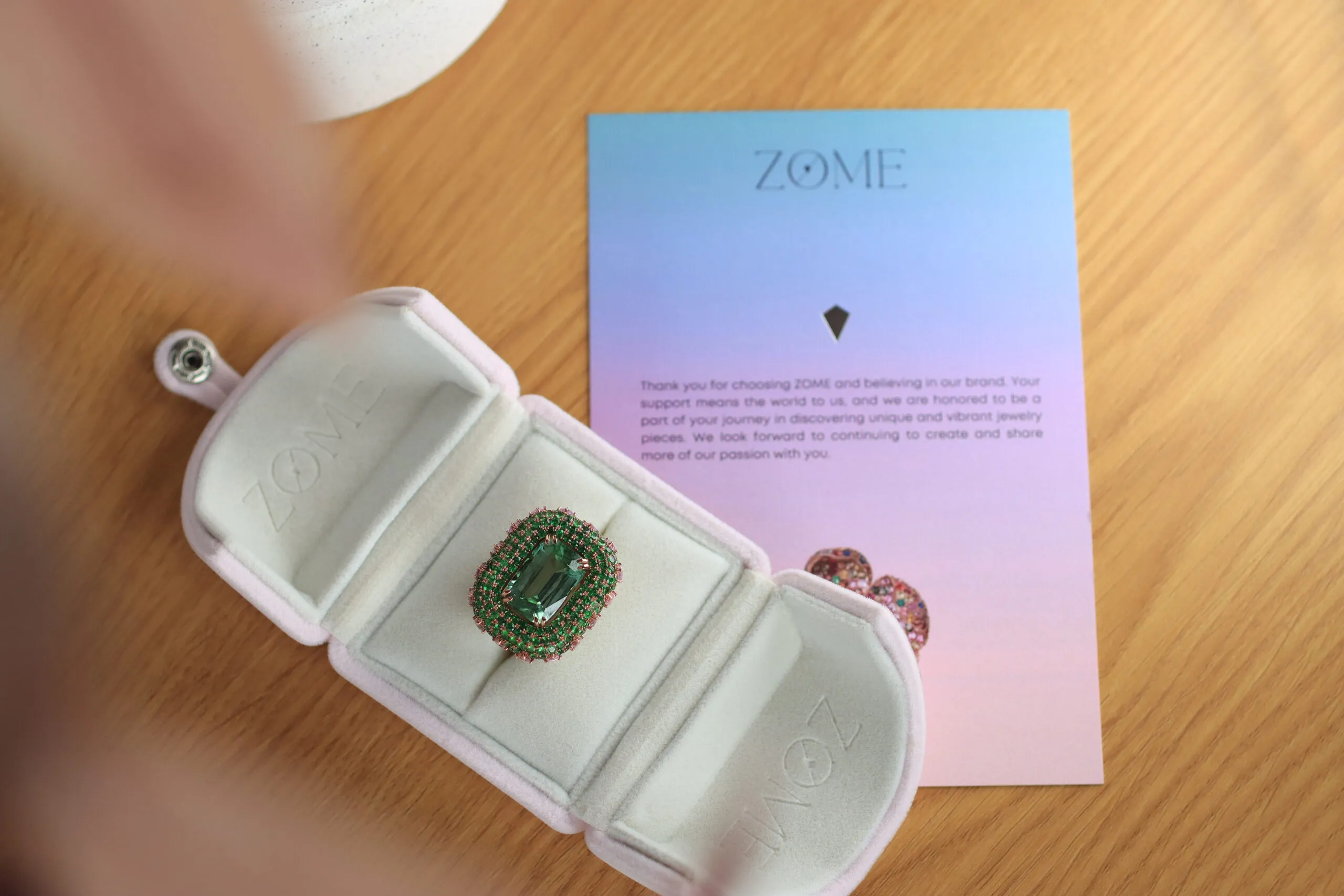 Zome Jewellery Eterna Verde ring from the Axia collection with an 11.63 carat green tourmaline, 12.37 carats of tsavorites, and 2.31 carats of kite-shaped pink sapphires in 18k rose gold 