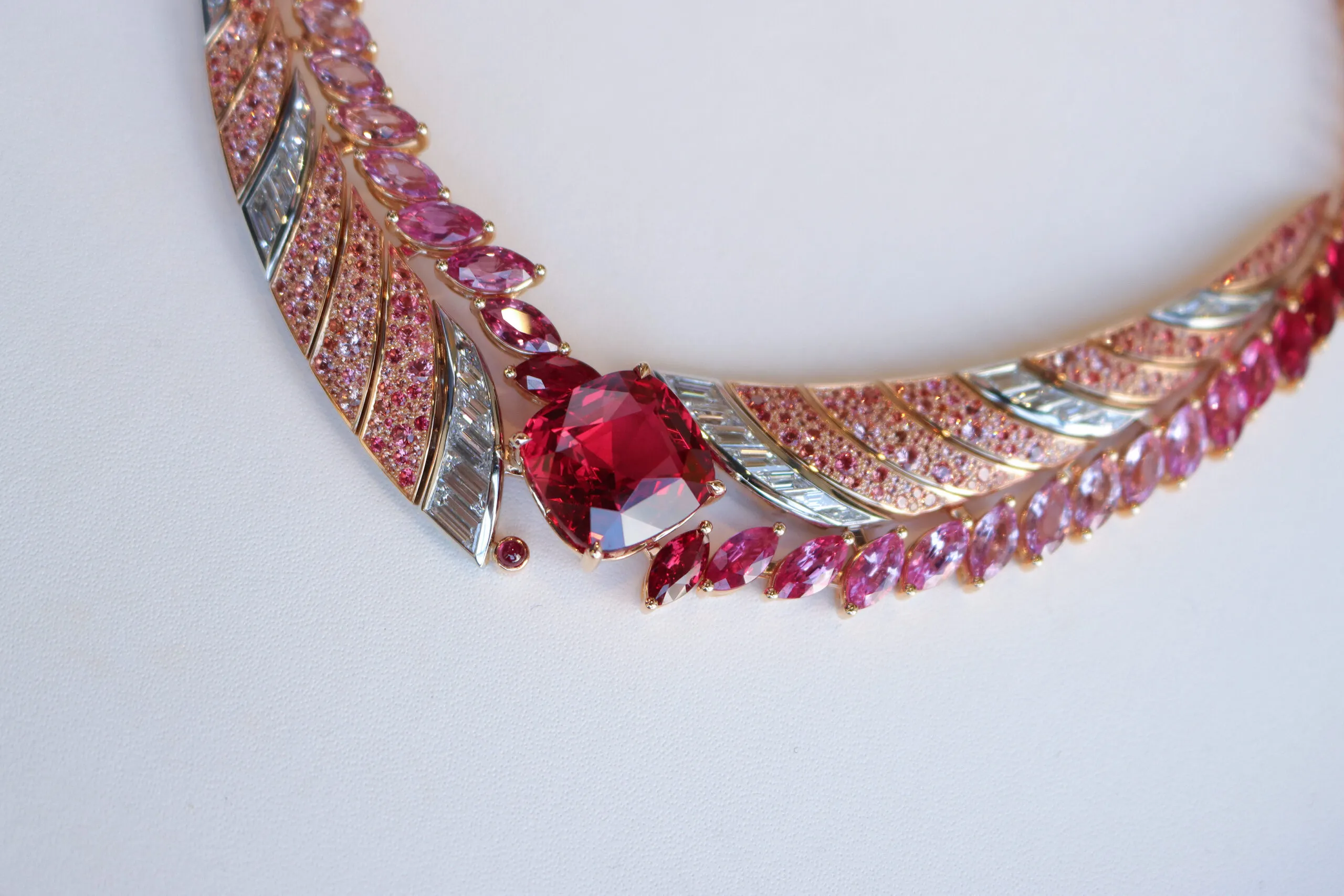 A closer look at the Tanzanian Sunrise High Jewellery necklace from the House of Gübelin with a 22 carat cushion-shaped red spinel, baguette-cut diamonds, orange and rose-coloured spinel pavé, and marquise-cut spinels, sapphires and rubies set in 18k rose gold and platinum 