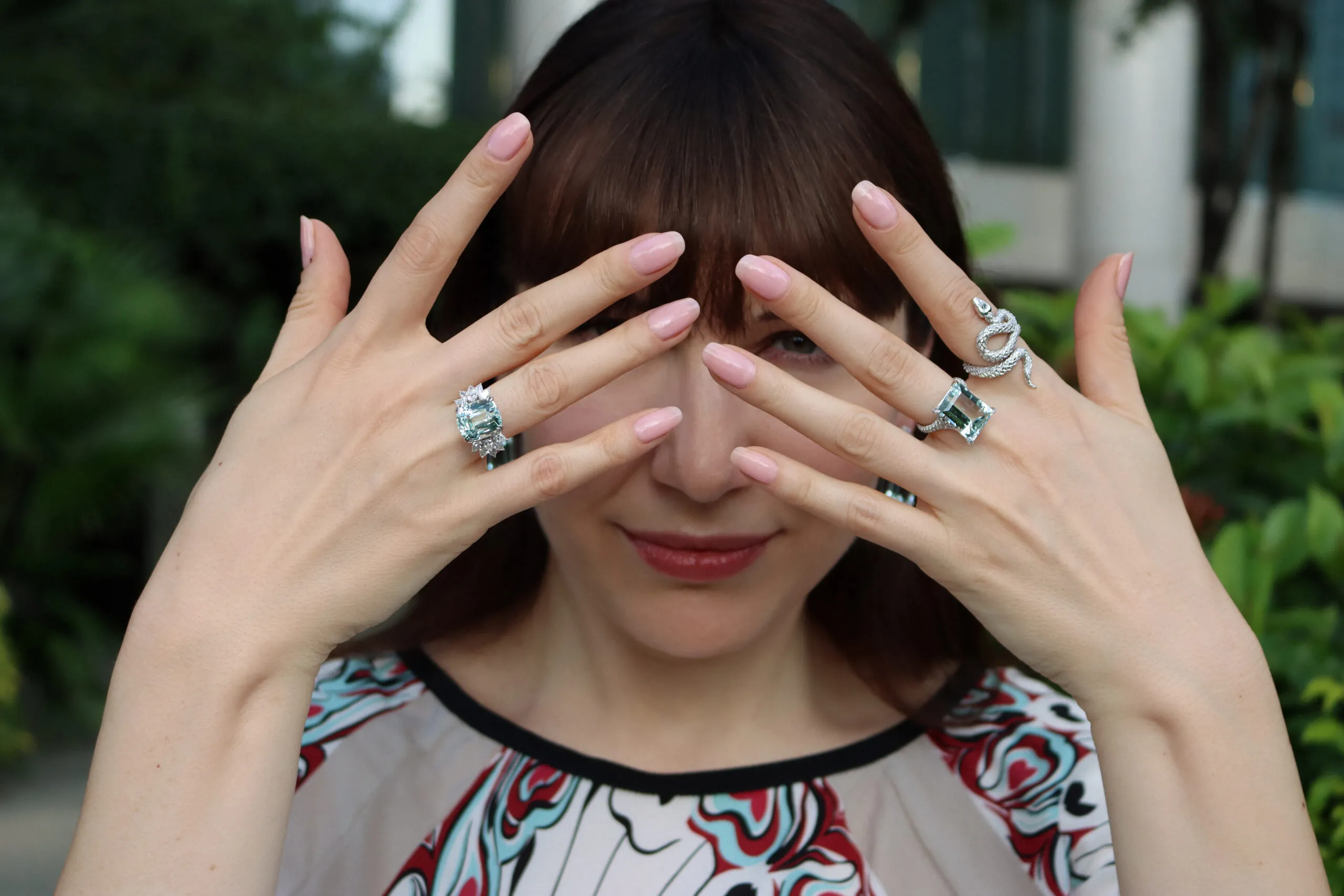 Katerina Perez wears rings by Valentina Fine Jewellery, including a 10.22-carat cushion-cut aquamarine ring (left) with 1.57 carats of diamonds, a 11.23-carat emerald-cut aquamarine ring with 1.02 carats of diamonds, and the Diamond Bamboo Pit Viper Snake ring with diamonds, all set in 18k white gold
