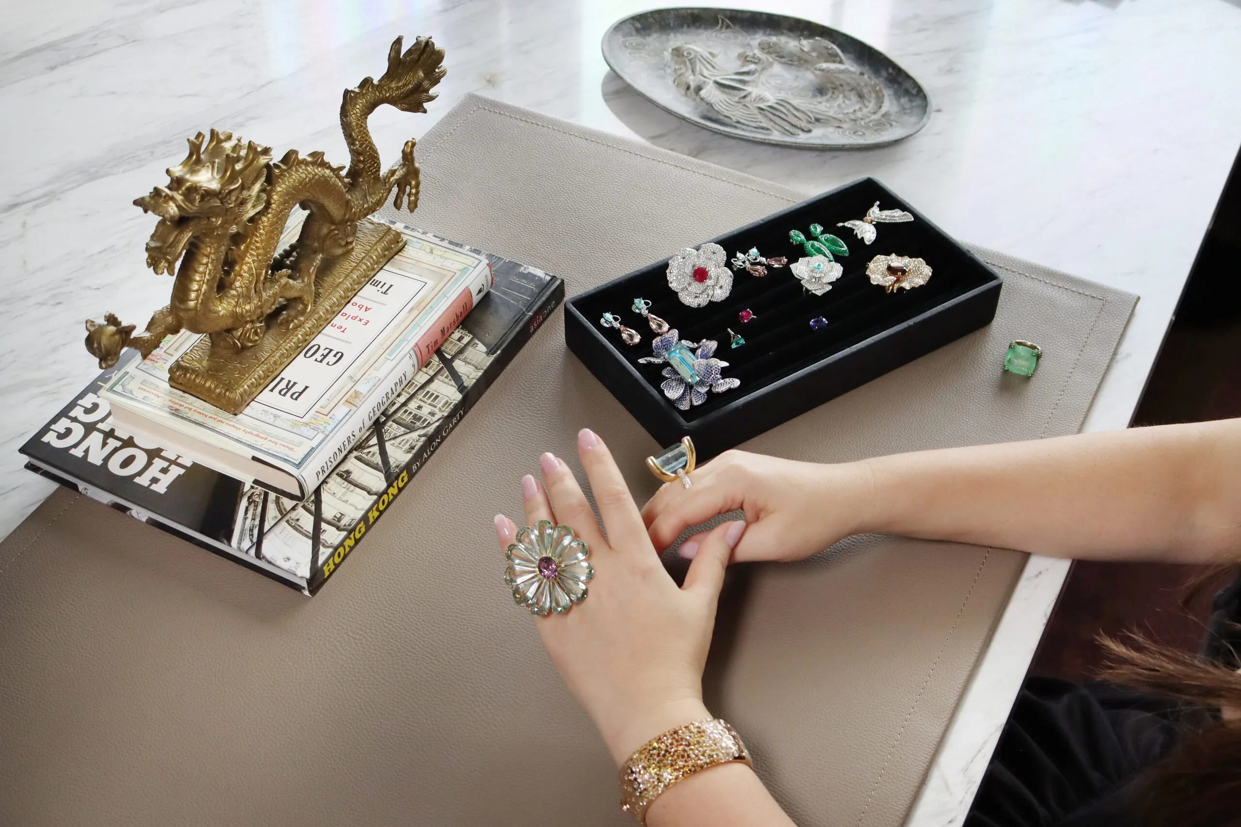 Katerina Perez tries on a selection of custom-made rings designed by Narcisa Pheres