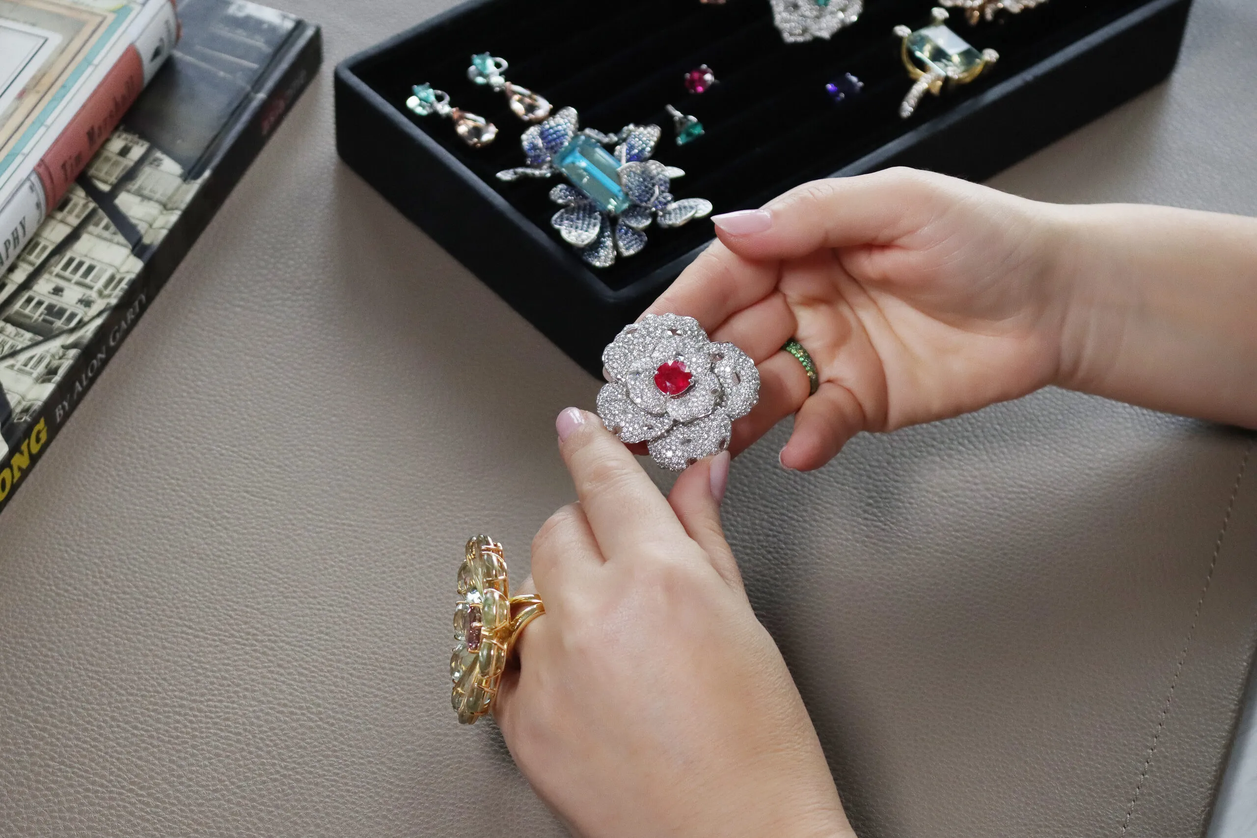 A floral-inspired ring by Narcisa Pheres with a ruby heart surrounded by pavé-set diamonds