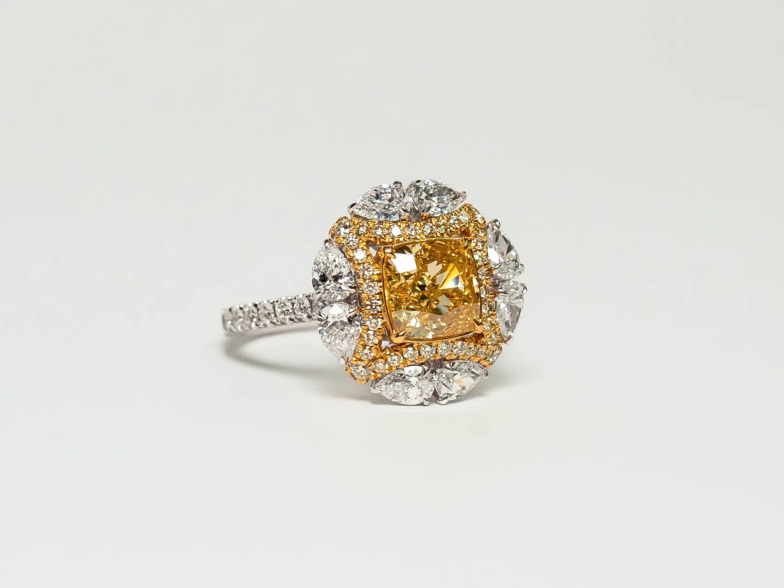 PHERES ring with a fancy yellow diamond centre stone, surrounded by colourless diamonds in 18k white and yellow gold 