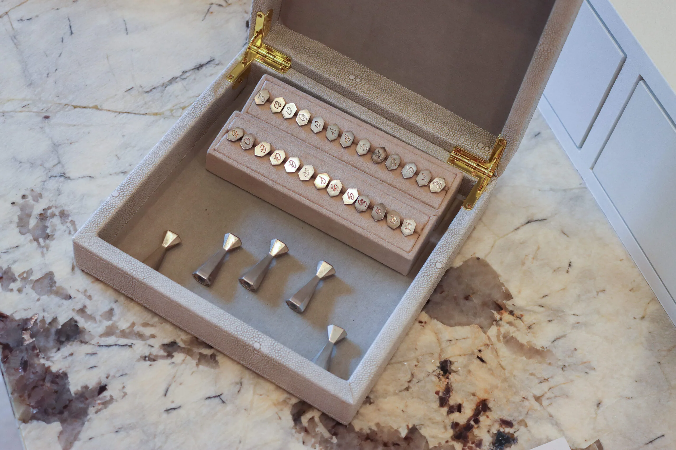 The B.P. de Silva Old World Charm™ collection blends the art of letter writing with fine jewellery in the form of Art Deco-inspired pendants that can transform into wax seals