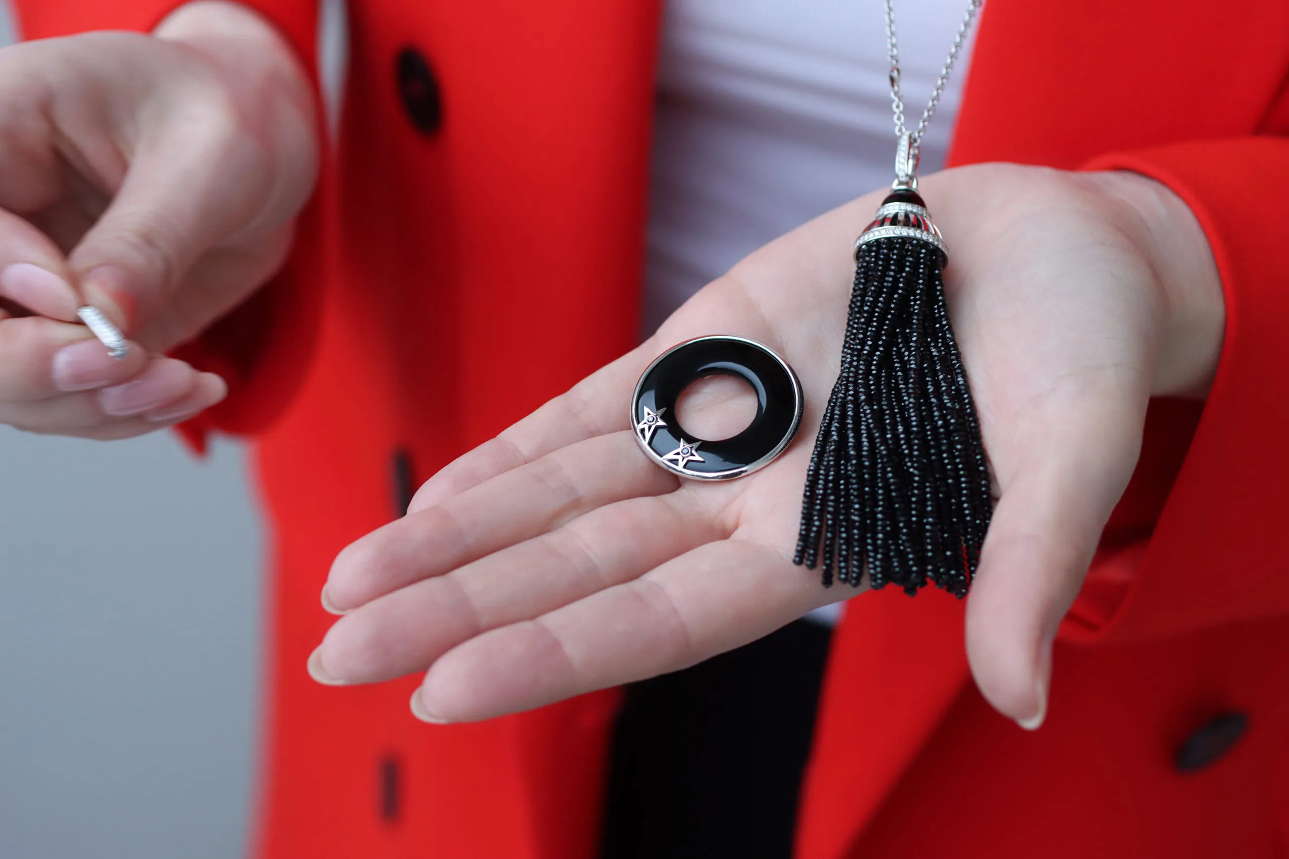 Katerina Perez demonstrates how the Elena Semy Jewellery Star Flight necklace can be worn without the circula pendant as a tassel of black spinel beads, totalling 85.75 carats