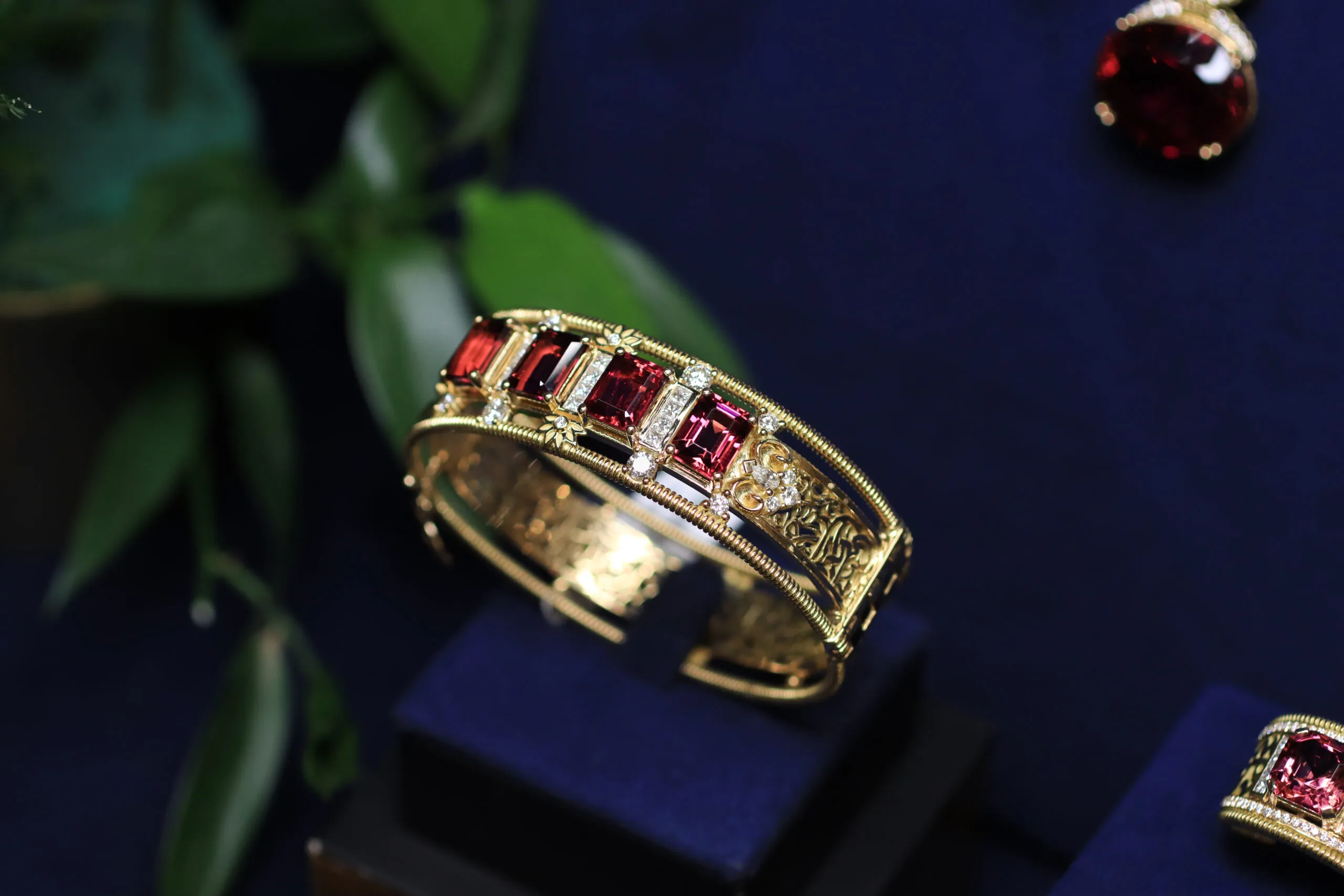 The Azza Fahmy Art Deco Calligraphy bangle from the second chapter of the Tales of the Nile High Jewellery collection, set with 11.64-carats of emerald-cut rubellites, diamonds and calligraphy in openwork yellow gold 