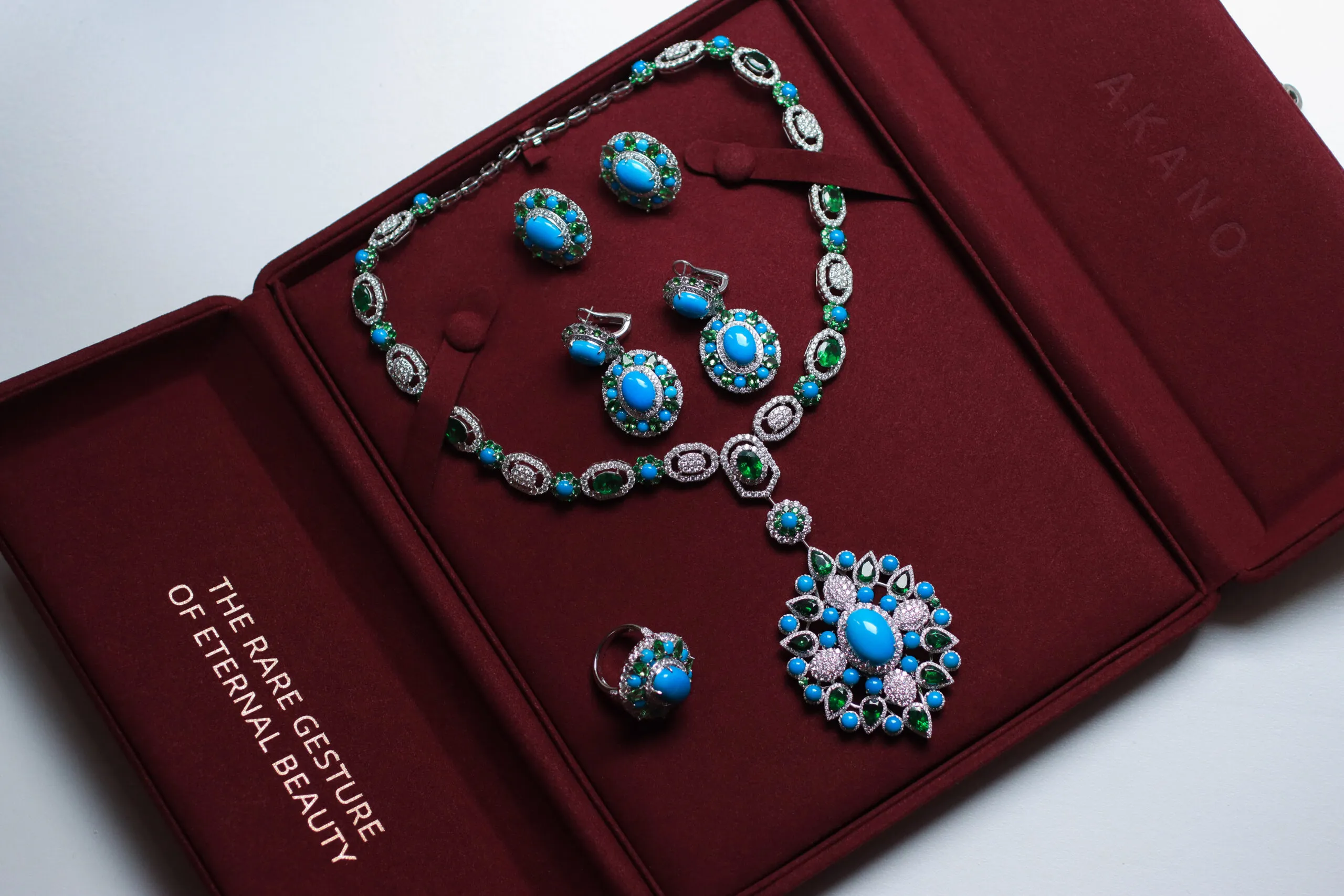 AKANO Chikaodili suite complete with a necklace, ring and earrings set with round turquoise, tsavorite, and diamonds in 18k gold 