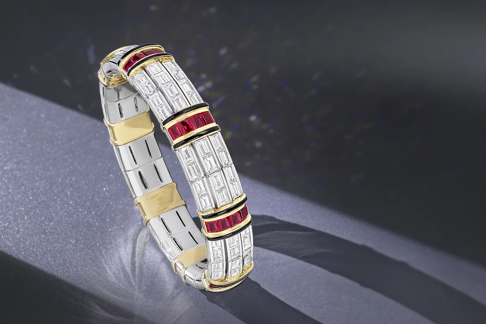 Impeccably Picchiotti Xpandable bracelet from the Picchiotti Classics collection with 32 buff top Burmese rubies totalling 8.80 carats, 18.88 carats of diamonds and onyx inlay set in 18k white and yellow gold