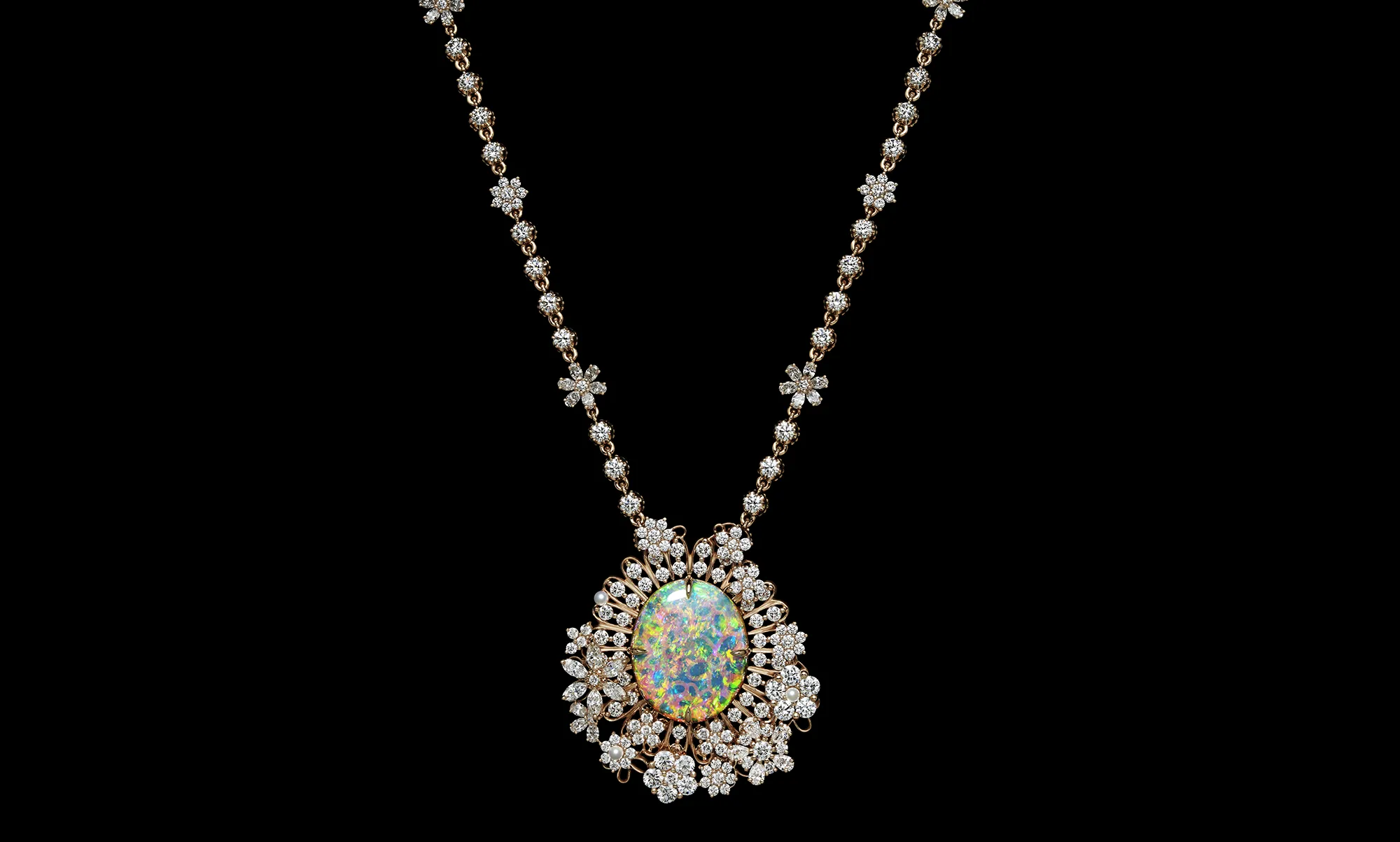 A second pendant necklace set with an impressive oval-shaped precious opal, surrounded by micro-pearls and diamonds from the Dior Milly Dentelle High Jewellery collection 