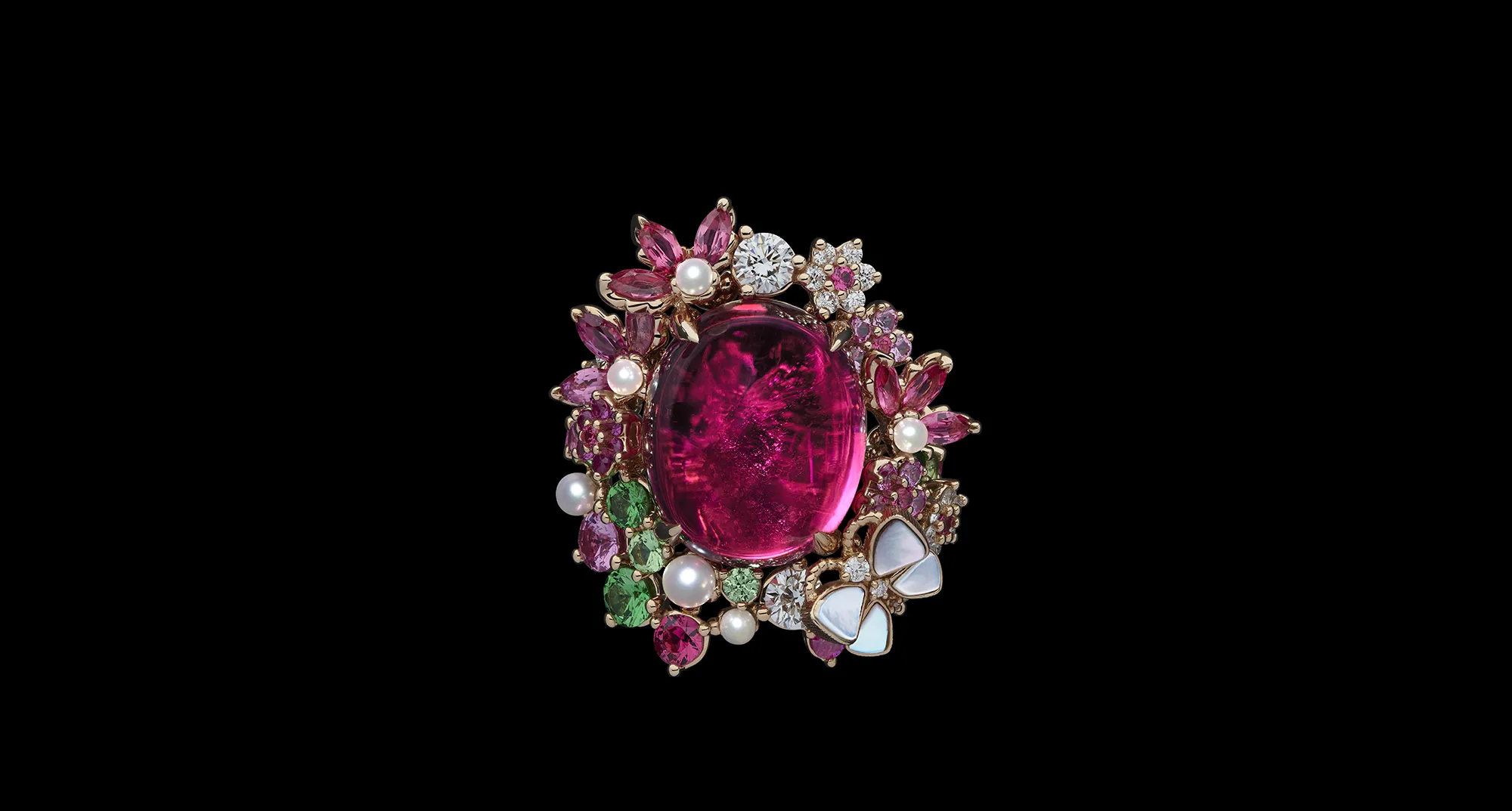 The Dior Milly Dentelle High Jewellery collection features significant gemstones, including this large ruby cabochon surrounded by further rubies, pink sapphires, demantoid garnets, micro-pearls and mother of pearl inlay 