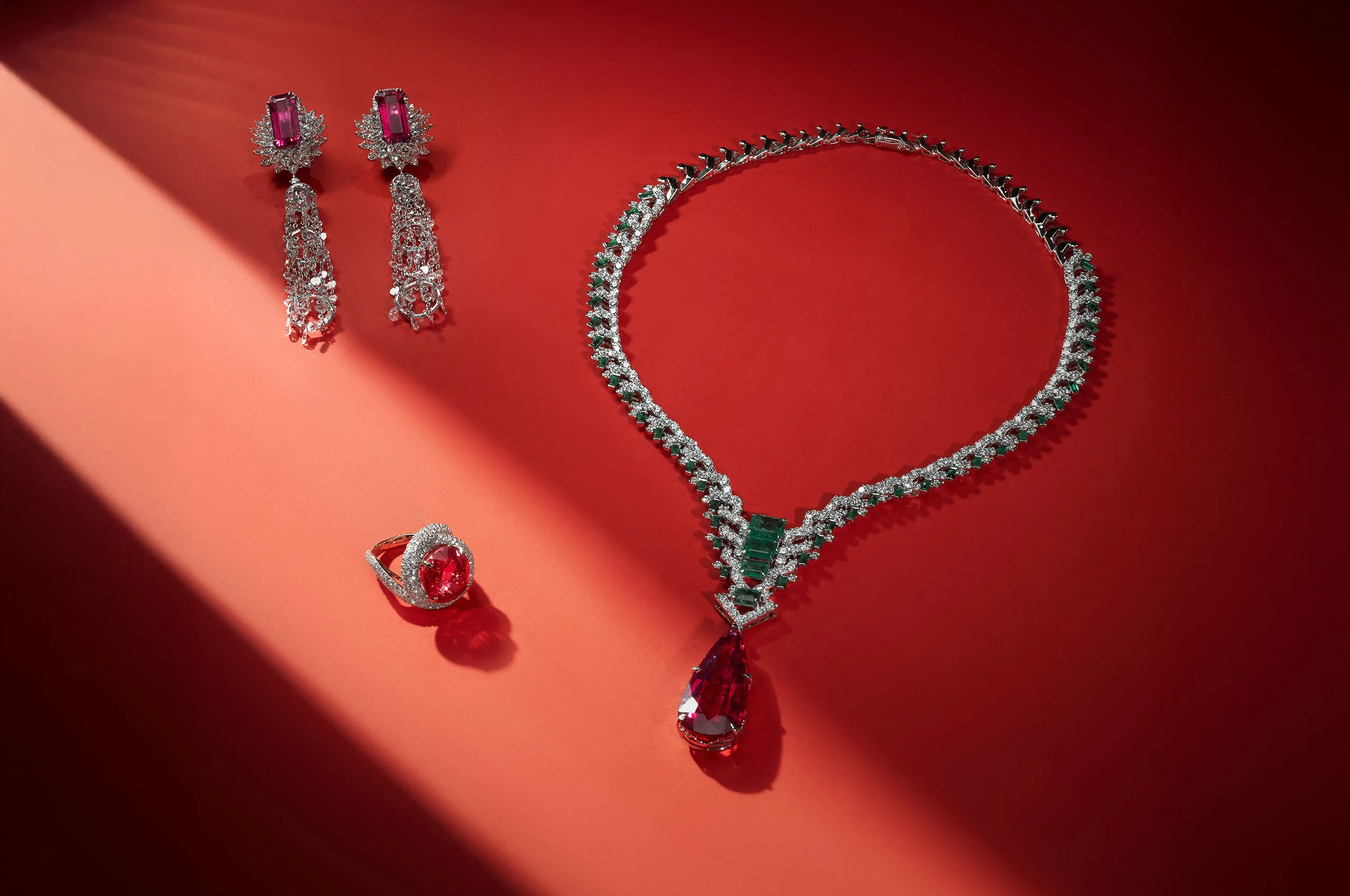 Jaipur Gems Phoenix Heart necklace with a 37-carat pear-shaped rubellite from Madagascar surrounded by diamonds and emeralds, shown here with the Rose of the Desert ring with a 15-carat rubellite and the Stardust Symphony earrings with 14 carats of rubellites and rose-cut diamonds  