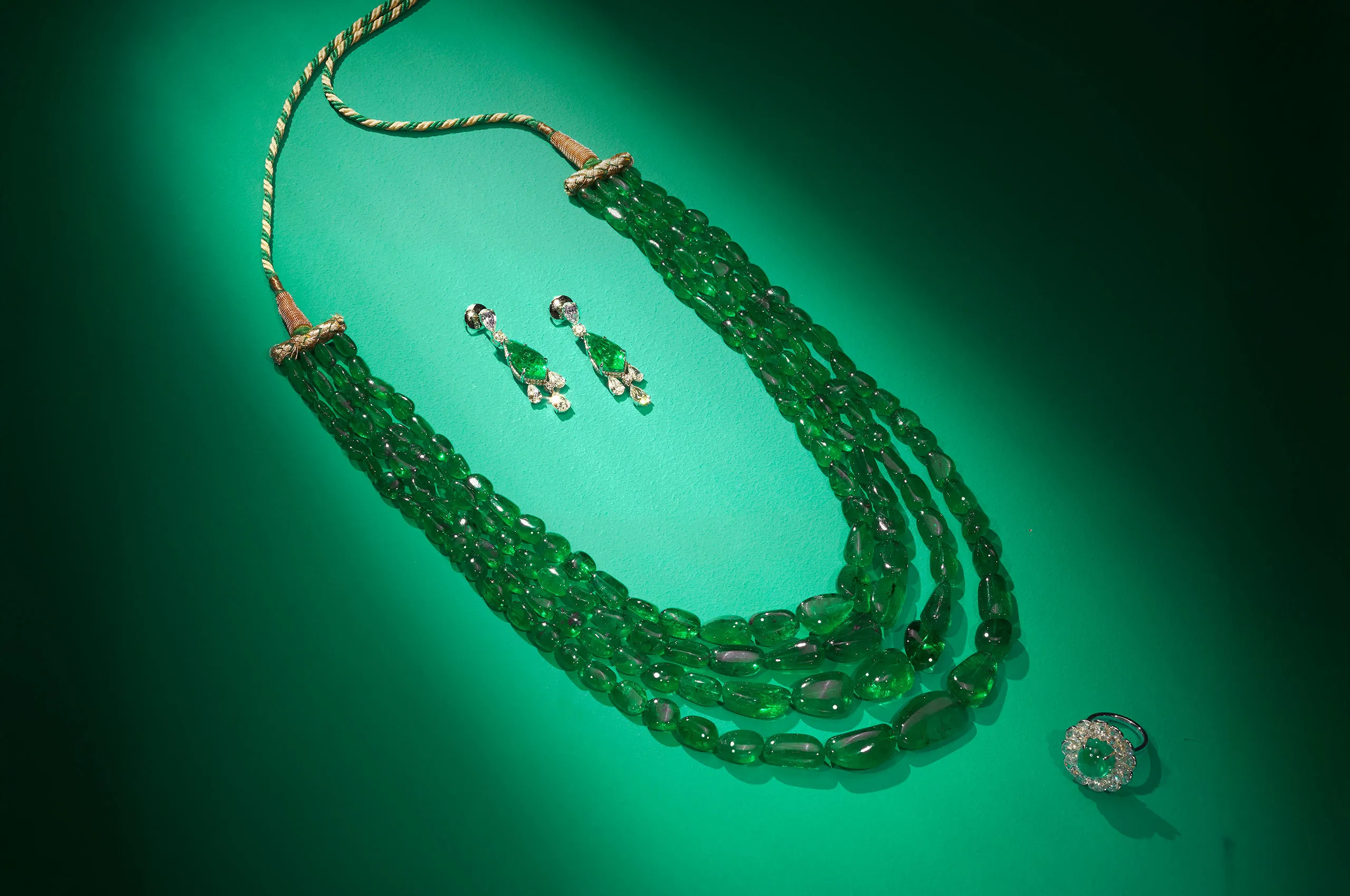 Jaipur Gems Serene Sanctuary necklace with over 860 carats of Colombian emeralds, shown here alongside the Starlit Gleam earrings with 16 carats of emeralds and the Halo’s Embrace ring with a 9-carat emerald and diamonds 