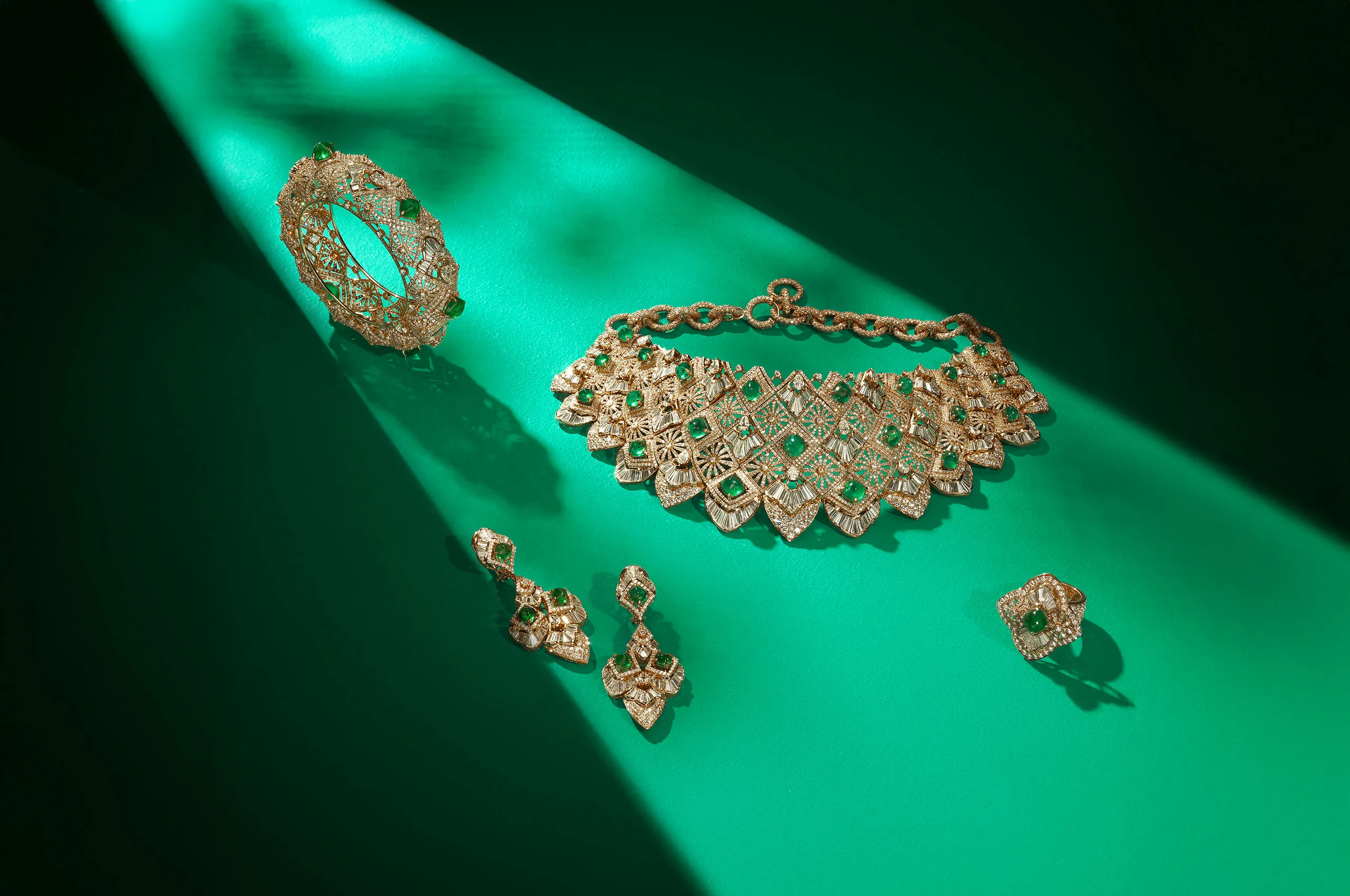 Jaipur Gems suite, including the Empress Emerald necklace with 58 carats of diamonds and 36 carats of emeralds crafted in 18k and 22k yellow gold, shown here alongside the Verdant Vine bangle, the Emerald Dewdrop earrings and the Verdant Spark ring 