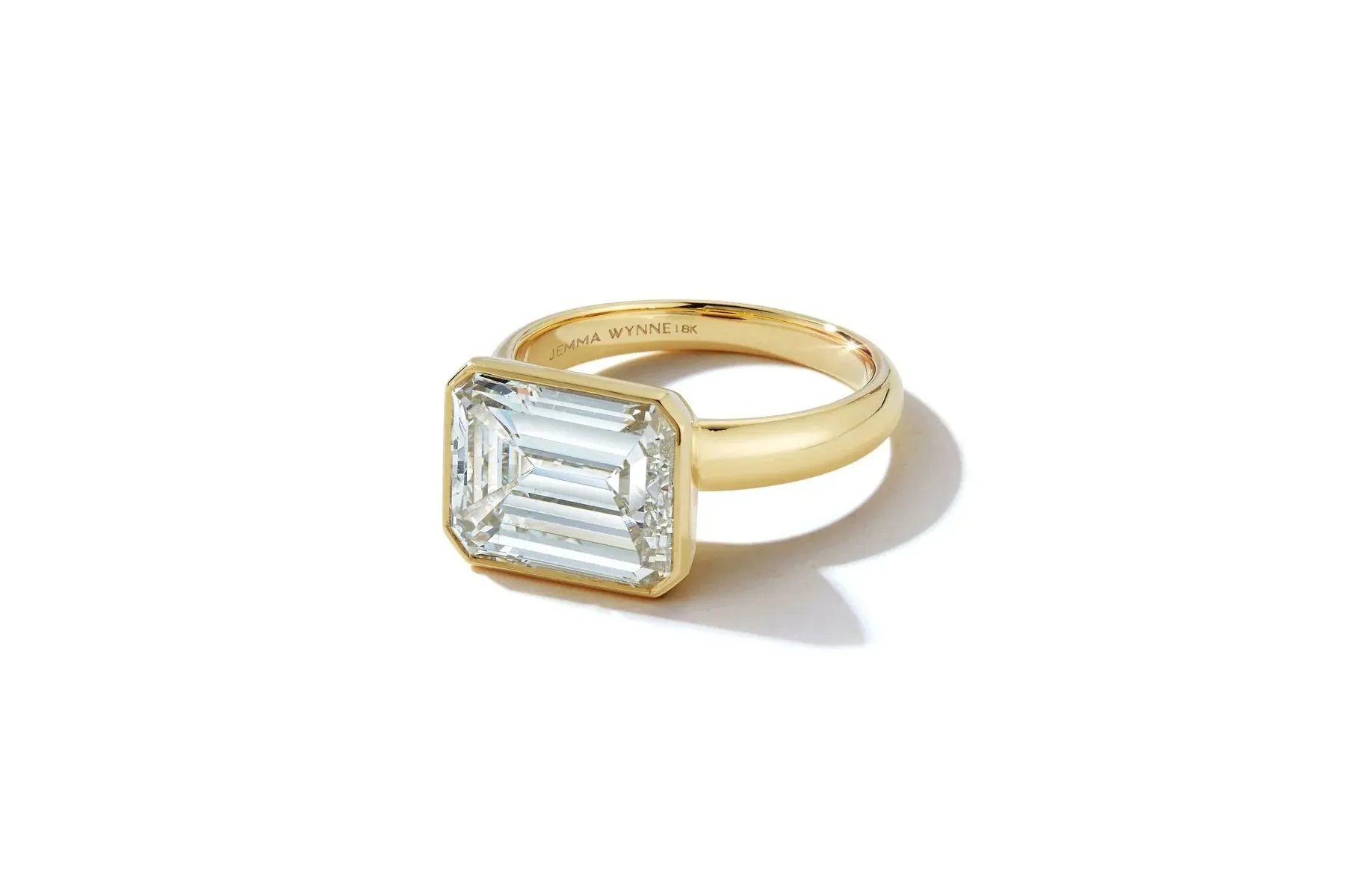 <p>Jemma Wynne east west diamond ring, set with a 5 carat emerald cut diamond in 18K yellow gold.</p>
