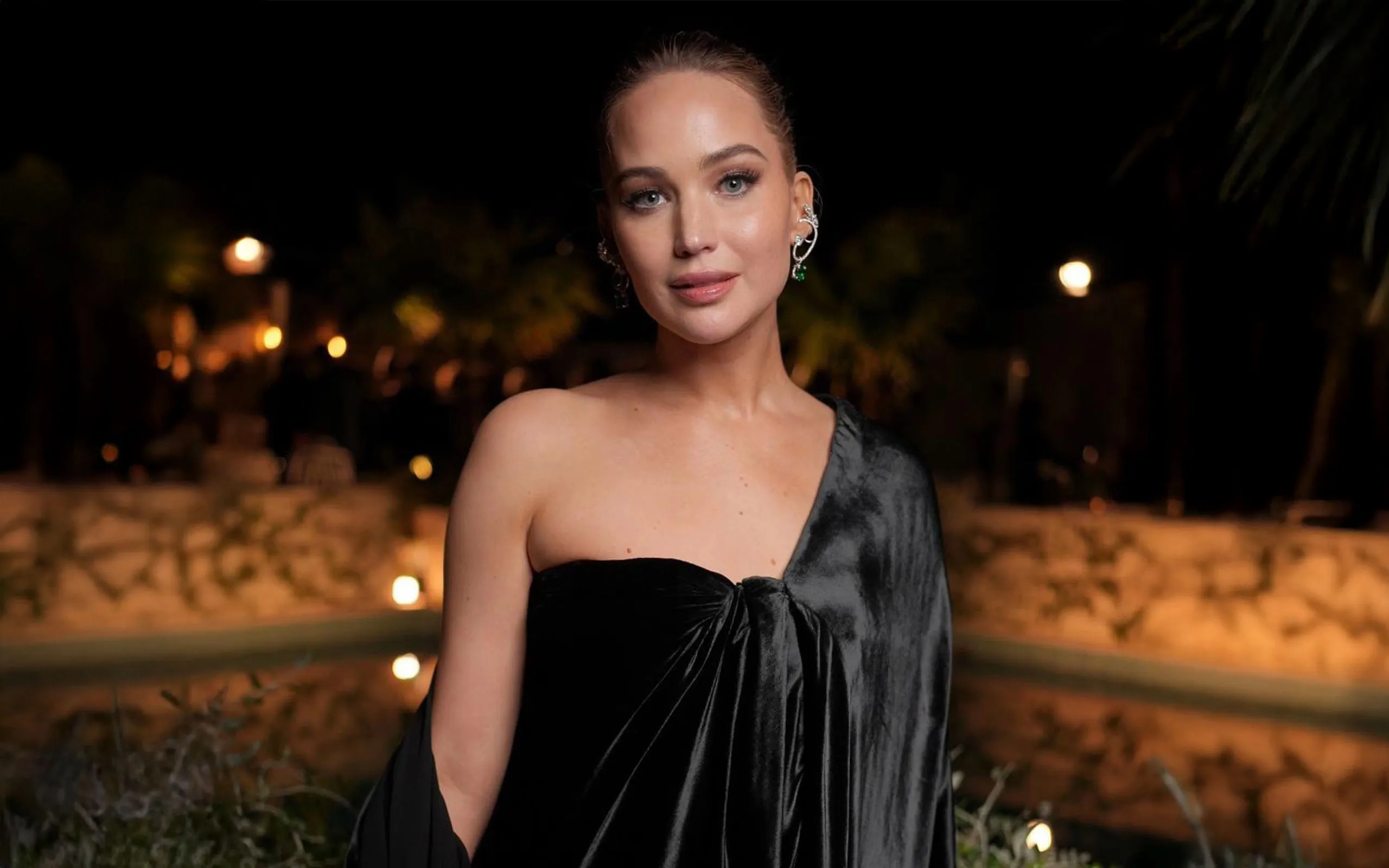 Actress Jennifer Lawrence wears the Diamond Georgia ear piece, the Diamond Lina ear piece and the Constance earrings with diamonds and emeralds, all by Ana Khouri, to the Cannes Film Festival 2025