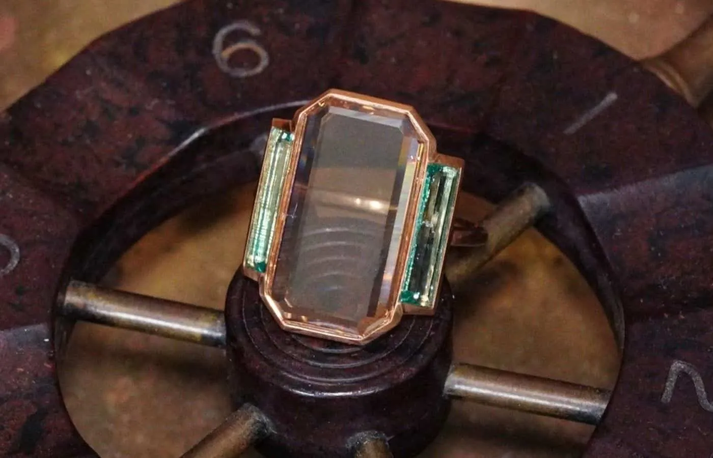  Jogani Art Deco-inspired ring with a 7.12 carat portrait-cut diamond and two step-cut emeralds in 20k rose gold 
