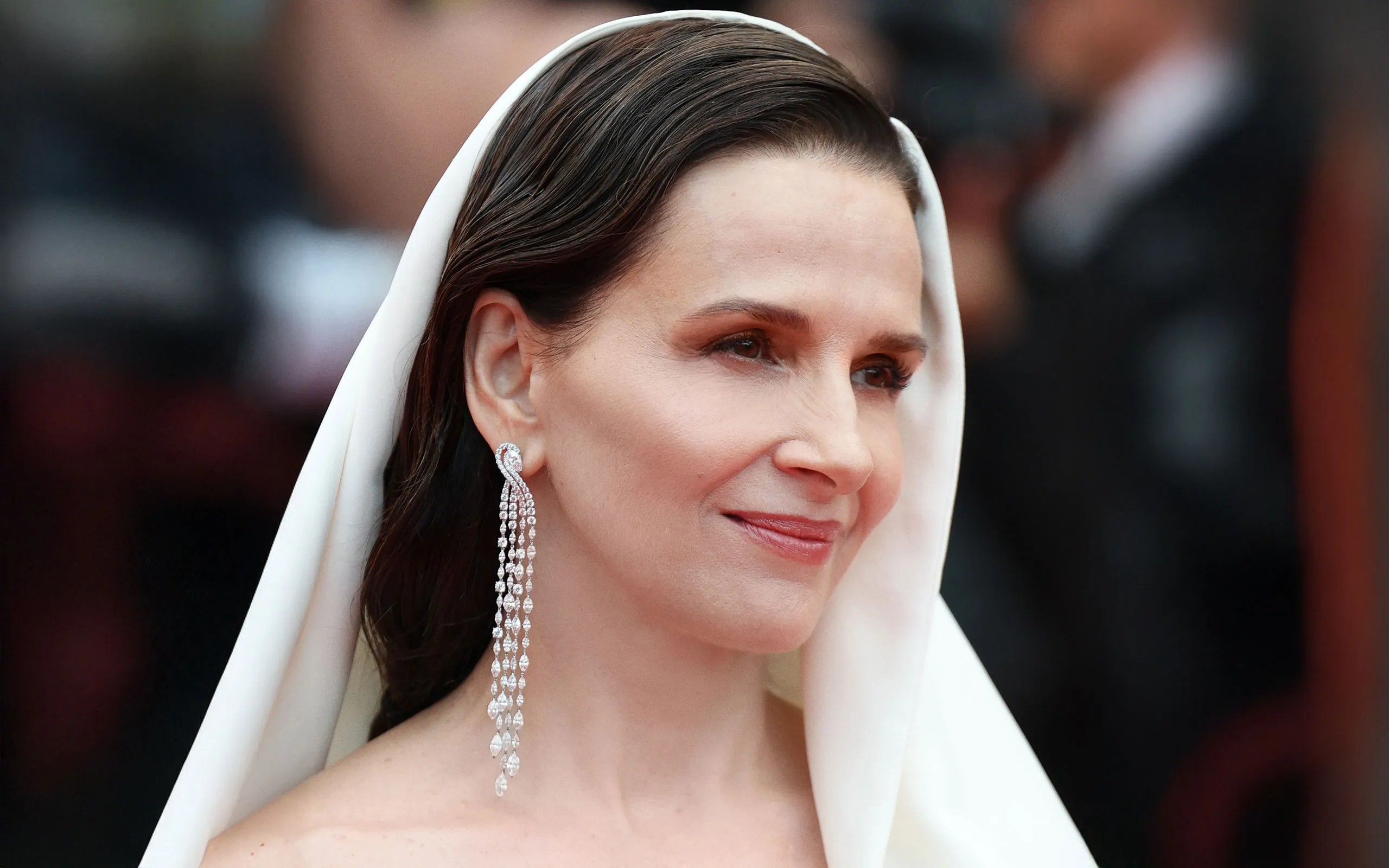 French actress Juliette Binoche wears a pair of Chopard diamond earrings to the Opening Ceremony of the Cannes Film Festival 2025
