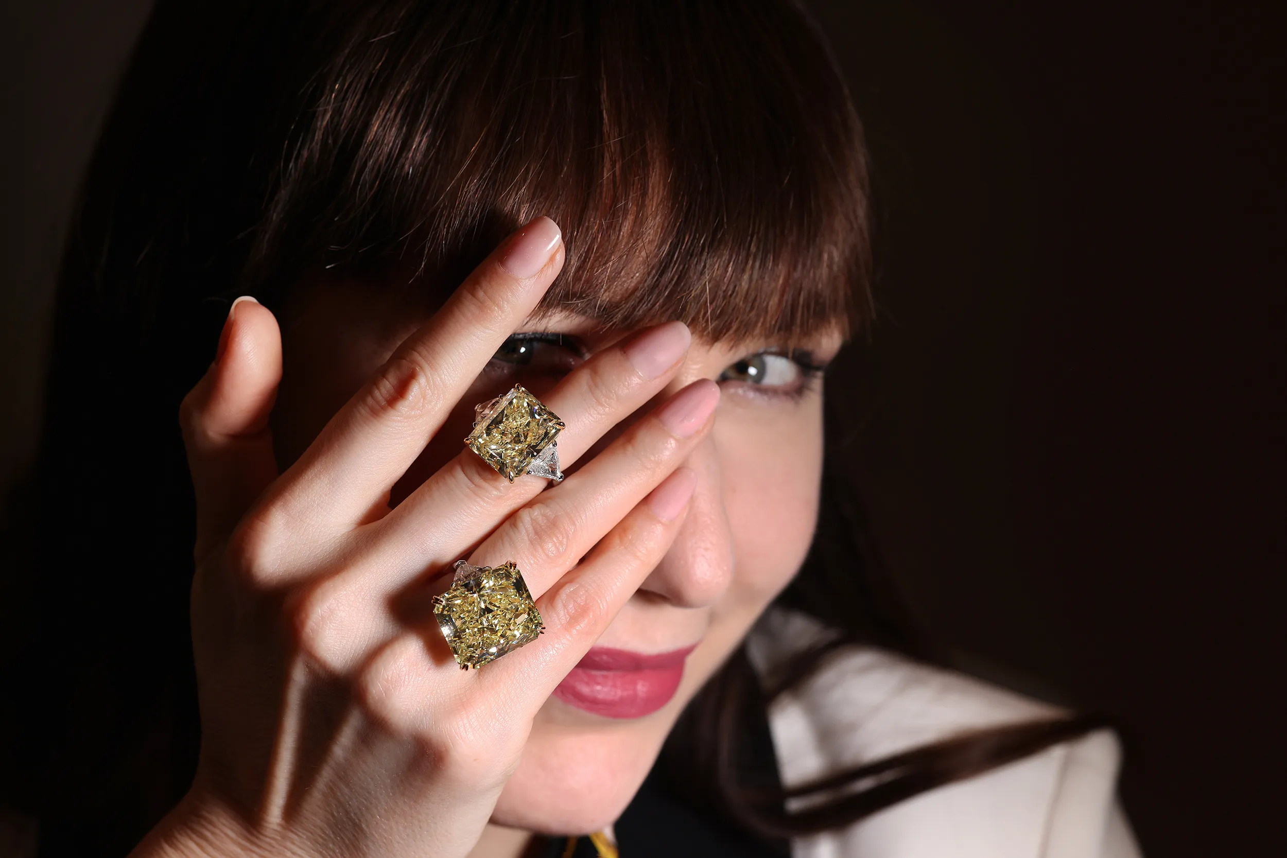 <p>Katerina wears 20 and 30 carat radiant cut Fancy Intense Yellow diamonds rings by Julius Klein</p>