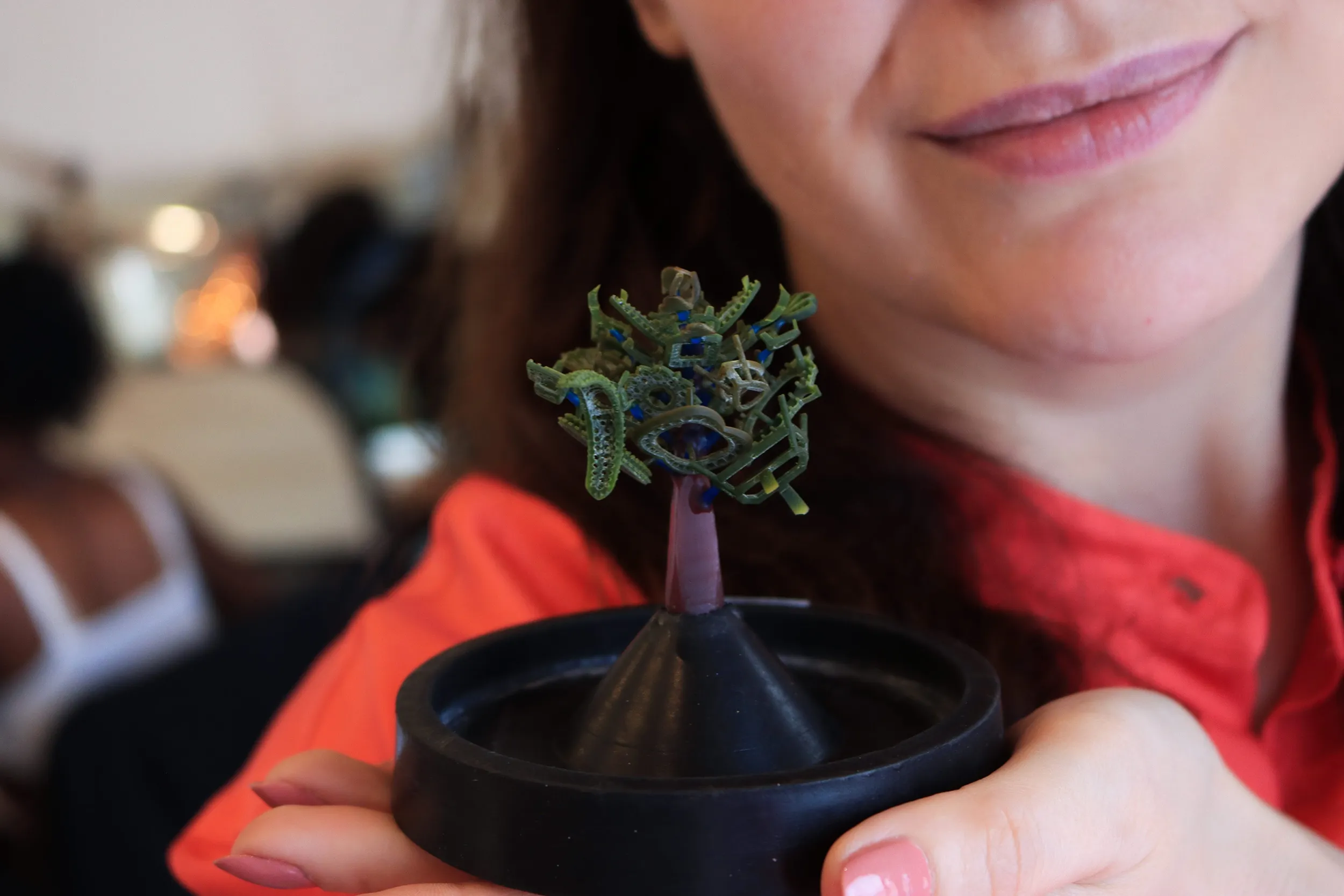 <p>Katerina Perez holds a casting tree – a structure made of wax or resin models of jewellery – allowing for multiple pieces to be cast simultaneously using the lost-wax casting process</p>
