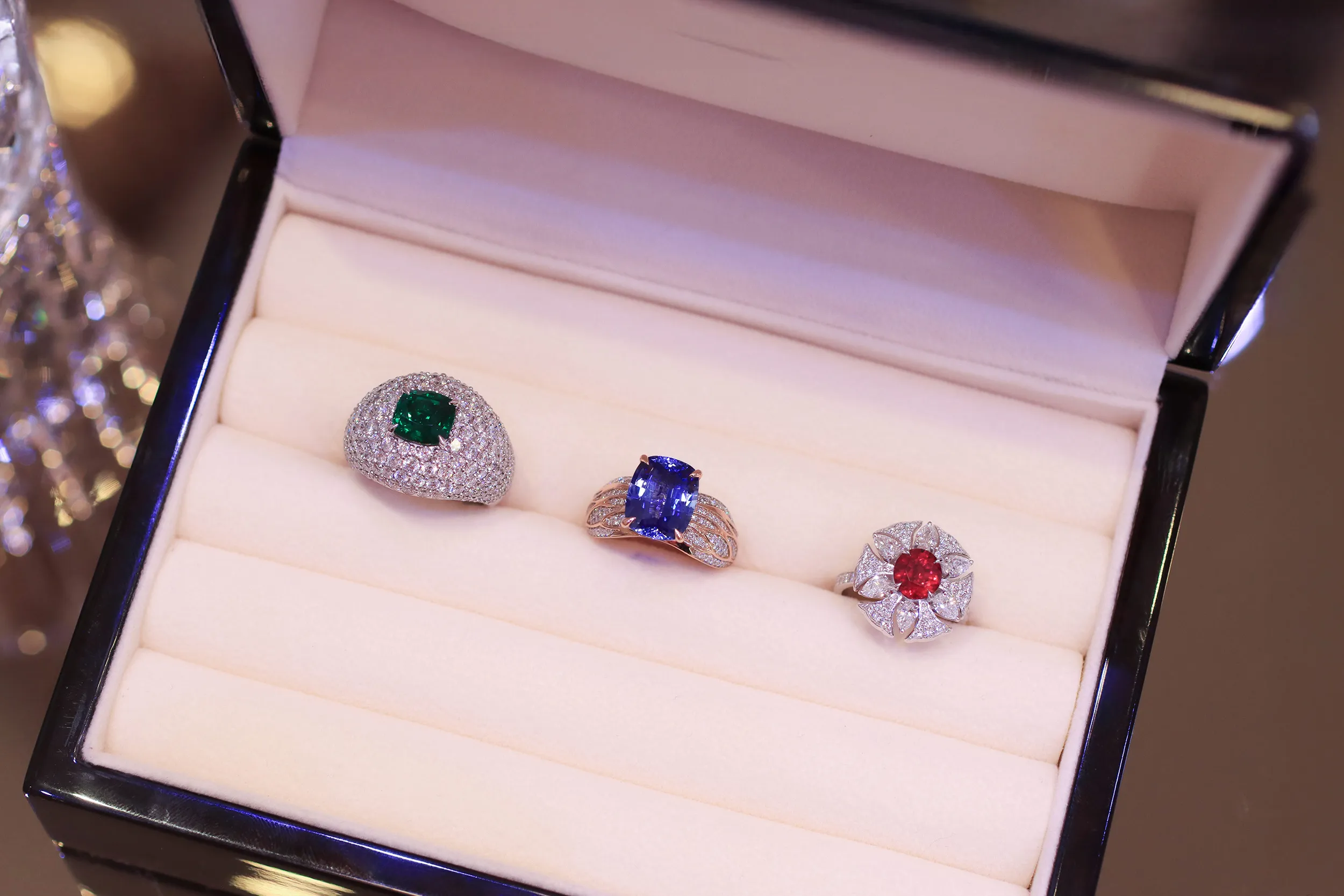 <p>A trio of cocktail rings by Morebelli including (from left to right) an 18k white gold ring with a 2.54 carat emerald and 228 diamonds, totalling 4.47 carats, an 18k rose gold ring with a 5.51 carat blue sapphire and 150 diamonds totalling 0.62 carats, and an 18k white gold ring set with a 2.05 carat ruby, six pear-shaped diamonds totalling 0.91 carats and 64 further diamonds with a total weight of 0.44 carats </p>
