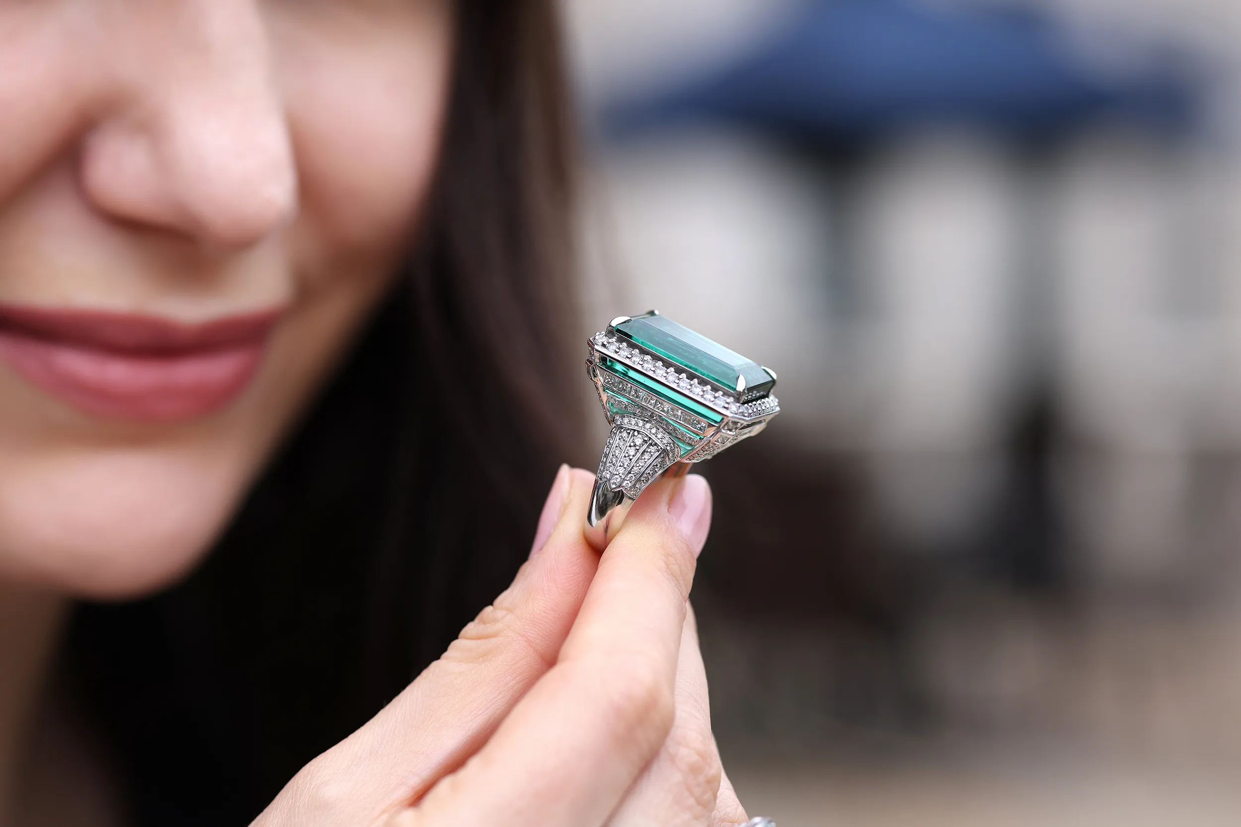 <p>Admiring the workmanship on the 39.21ct emerald cut titanium tourmaline ring</p>