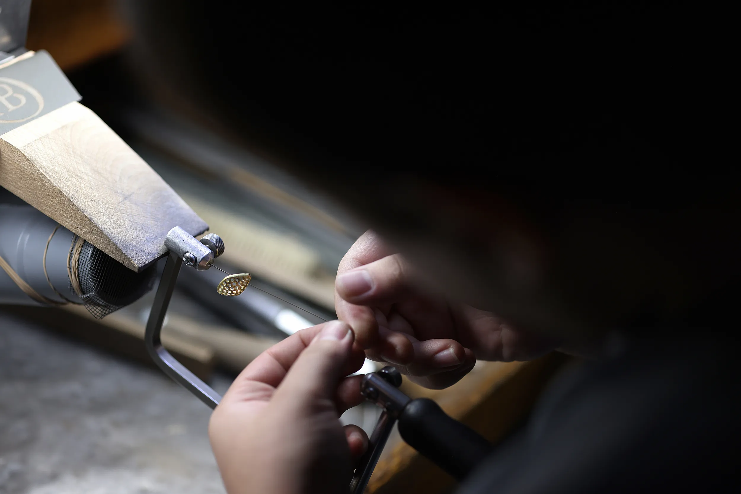 <p>A pave ‘chicklet’ earring is carefully cleaned by hand by an Oscar Heyman jeweller</p>
