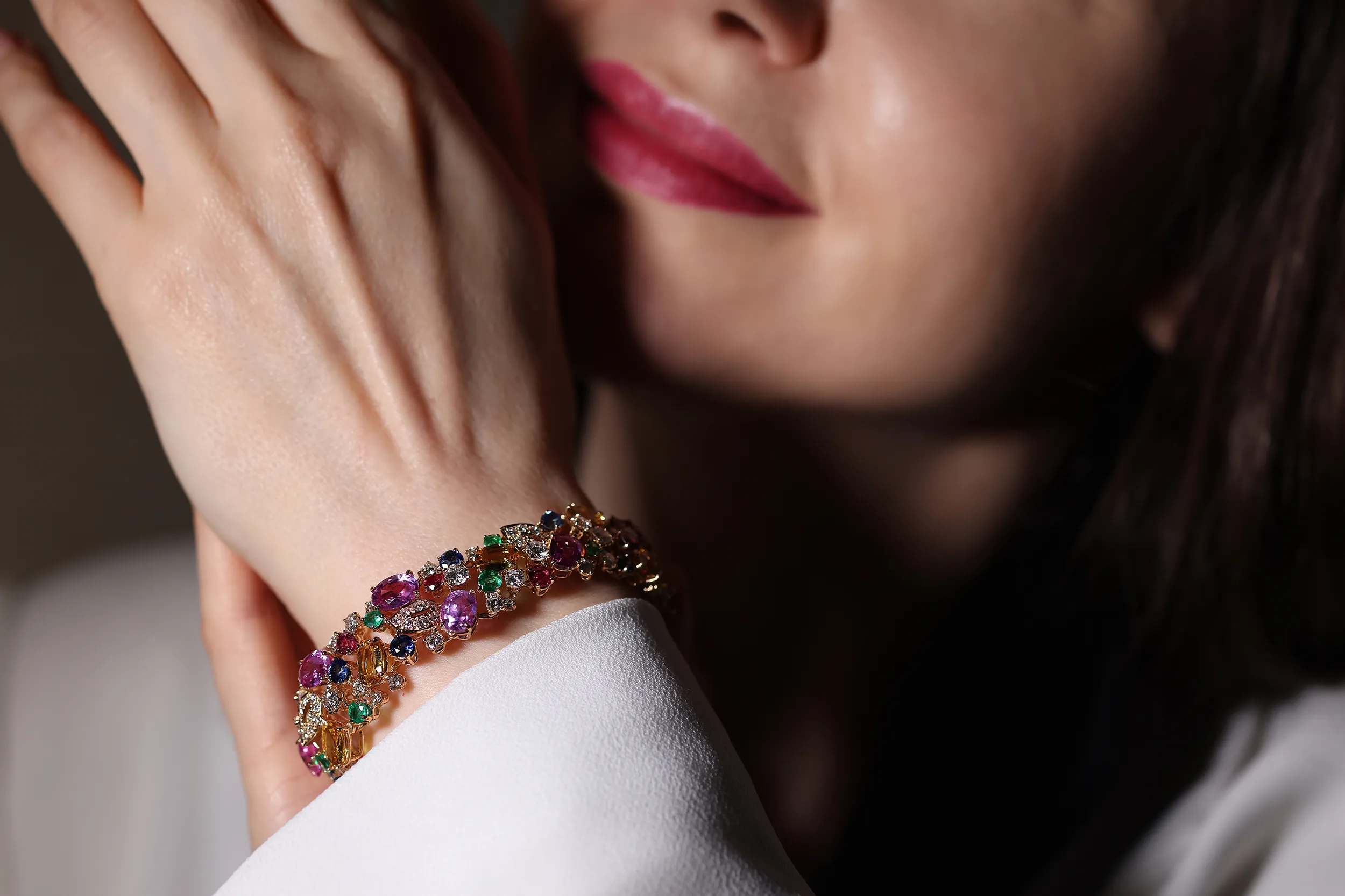 <p>An intricate mosaic of multi-coloured sapphires, rubies, emeralds and diamonds. A scatter bracelet like this can take up to six months to complete. The stone buying team collects the suite of stones, with a keen eye for balance in shape, size, cut, lustre and vibrancy. Then, the in-house lapidary matches table heights and crowns to ensure each stone is pristine</p>

