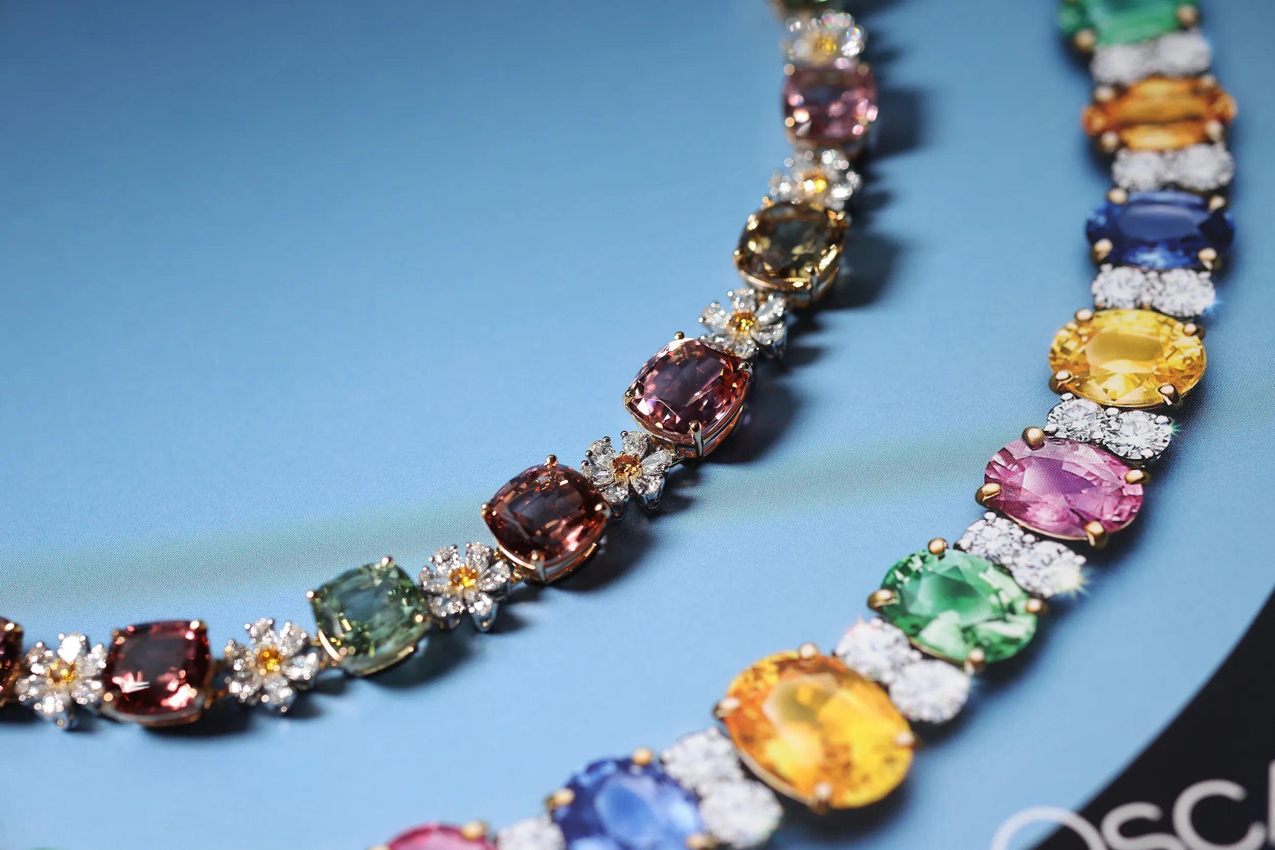 <p>A multi-colour tourmaline necklace dotted with delicate flowers crafted from diamonds and fancy diamonds</p>
