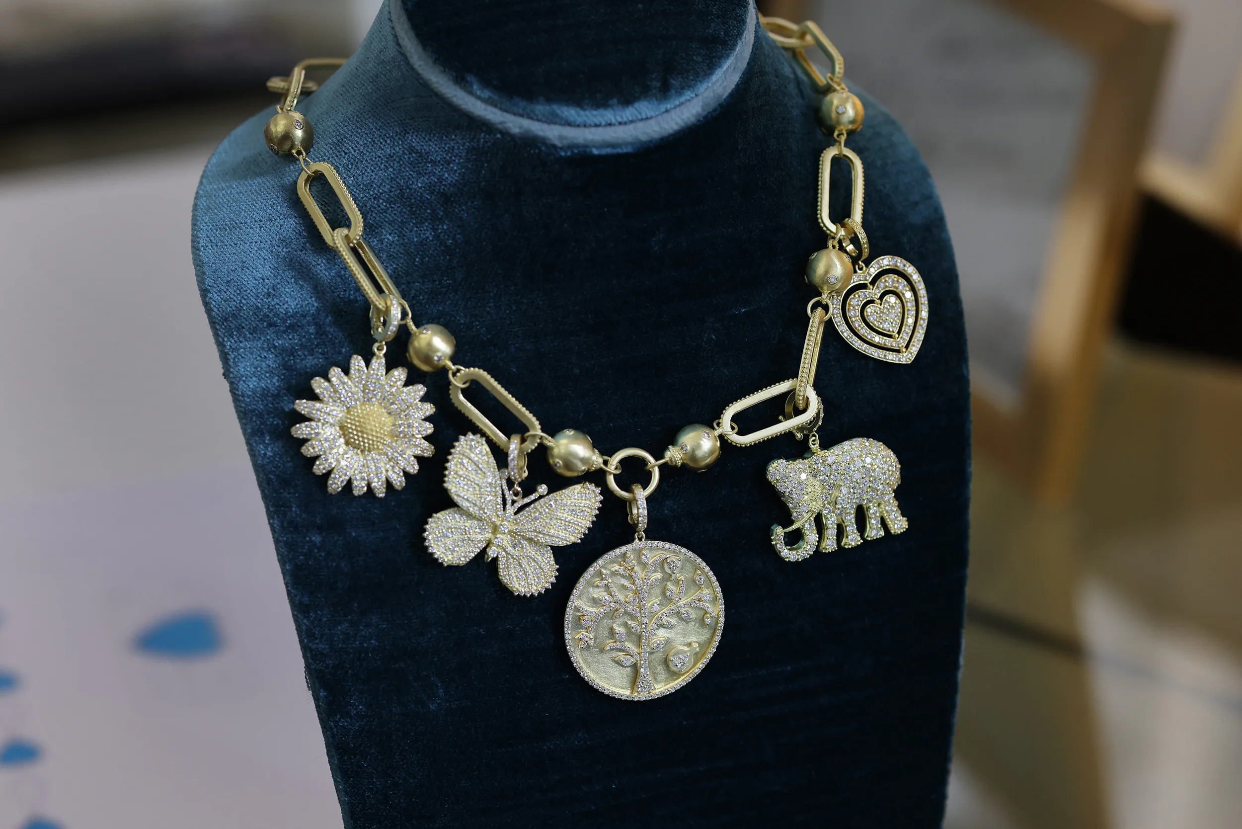 <p>The Tanya Farah Fine Jewelry &#8216;build your own’ charm necklace with butterfly, elephant, tree of life, heart and daisy-inspired charms with diamonds in 18k yellow gold</p>
