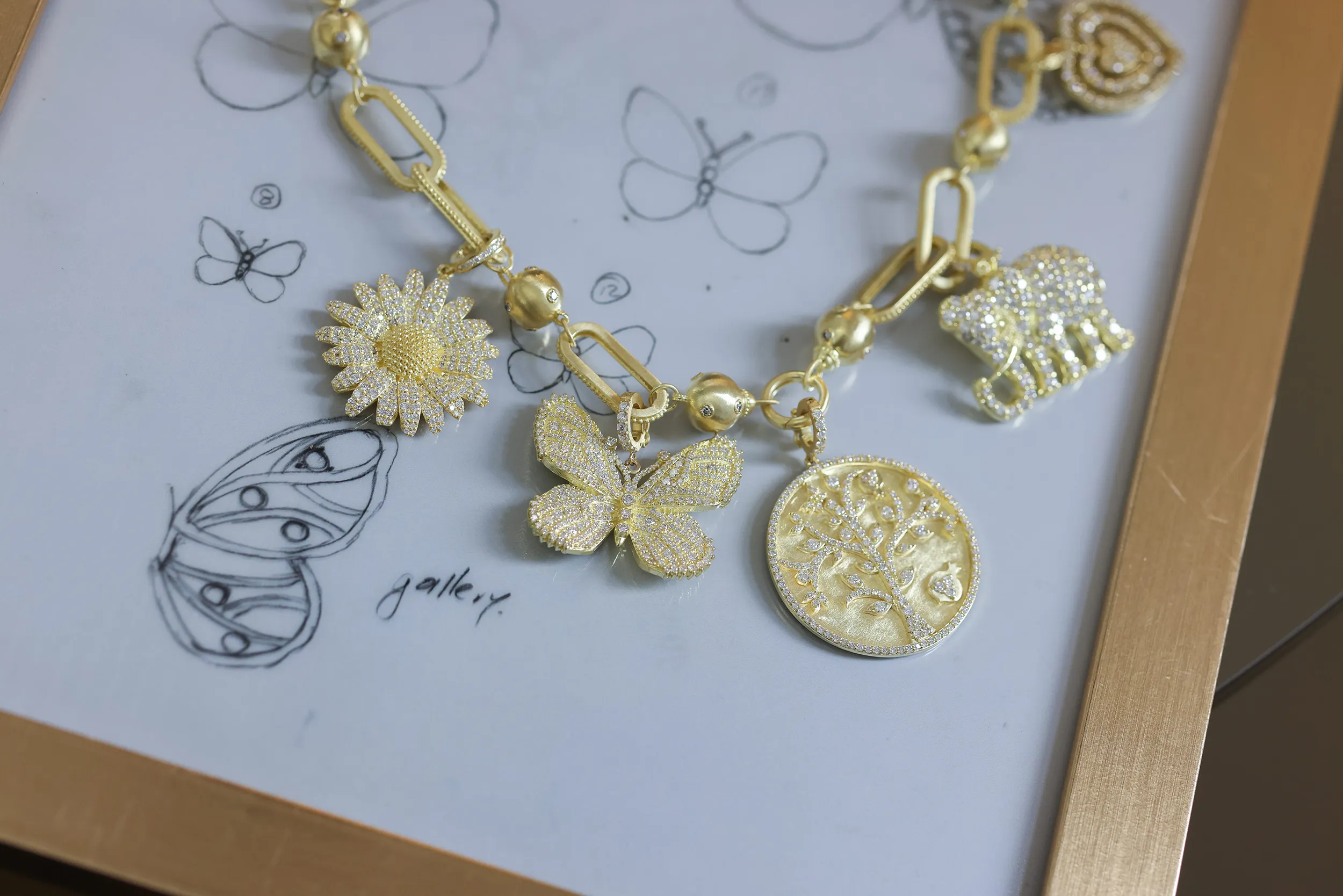 <p>The Tanya Farah Fine Jewelry &#8216;build your own’ charm necklace with butterfly, elephant, tree of life and daisy-inspired charms with diamonds in 18k yellow gold</p>
