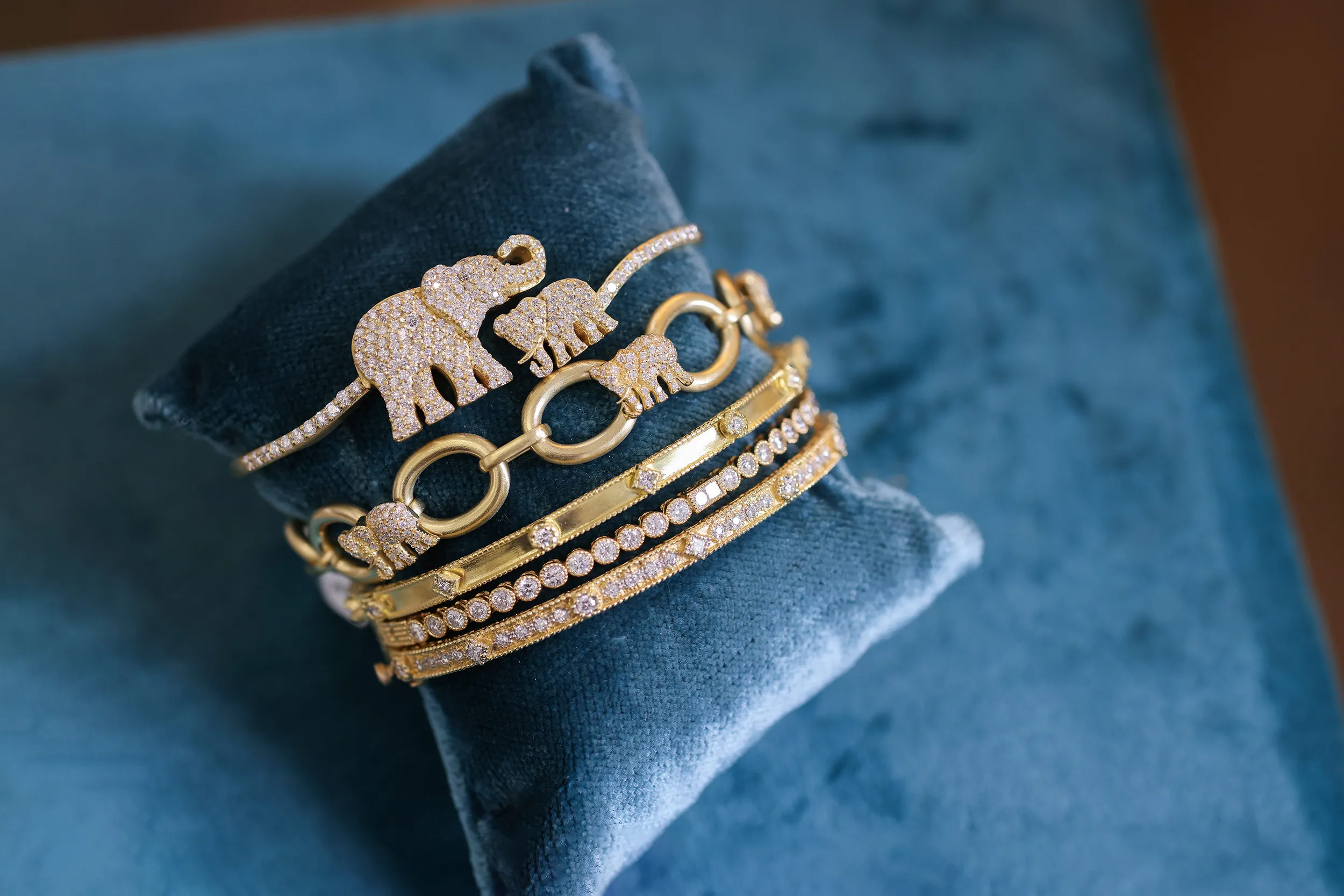 <p>Tanya Farah Majestic Elephants diamond bypass bangle and Majestic Elephants link bracelet, pictured here with a selection of diamond stacking bangles from the Modern Etruscan collectiono</p>
