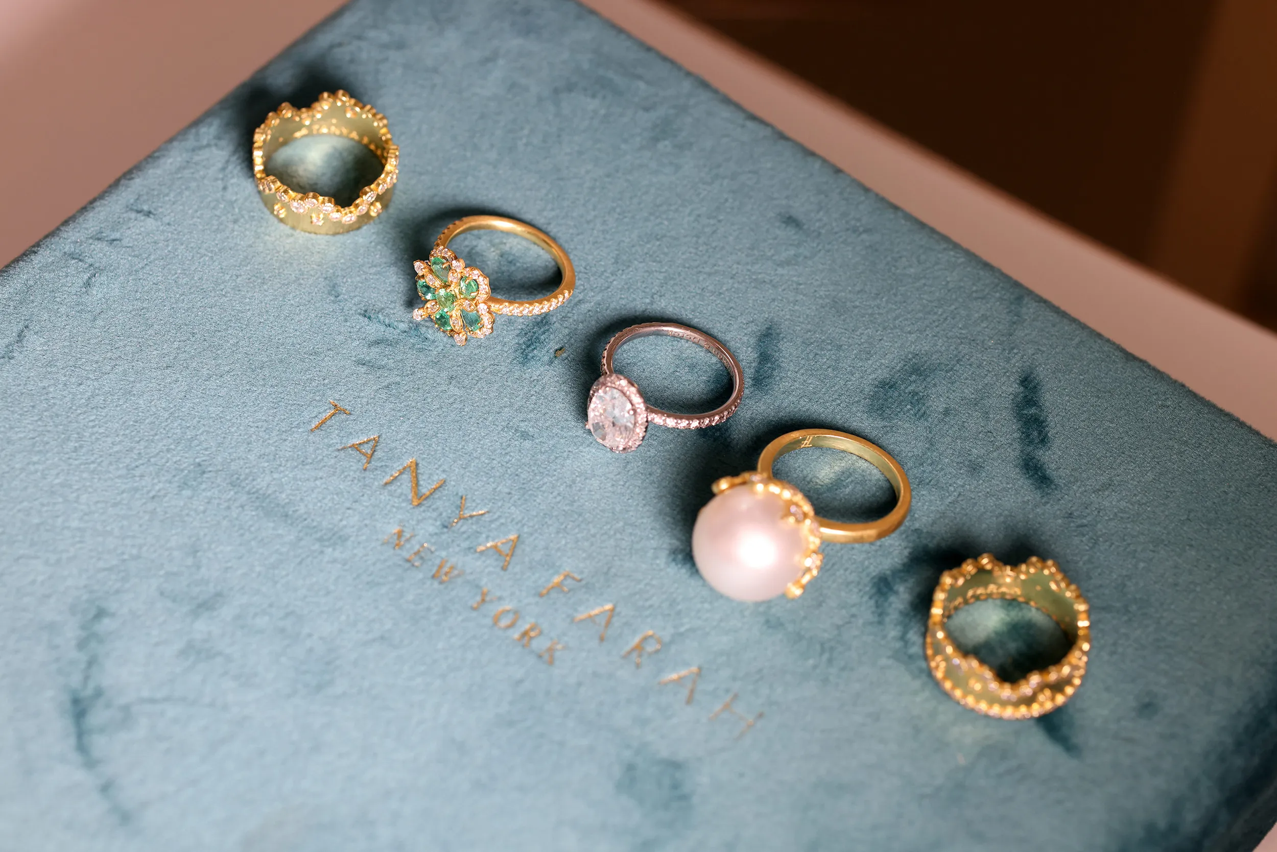 <p>Tanya Farah Fine Jewelry rings including (from left to right), the Modern Etruscan Crown diamond ring, the Jasmine Bloom small emerald and diamond ring, a Bespoke Oval diamond engagement ring, the Modern Etruscan South Sea pearl and diamond ring, and the Modern Etruscan Crown diamond ring</p>
