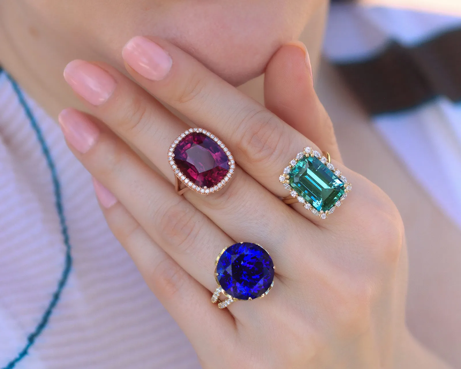 A selection of Lisa Nik cocktail rings from the Colors collection, including a round tanzanite, a cushion-shaped rubellite, and an emerald-cut indicolite tourmaline