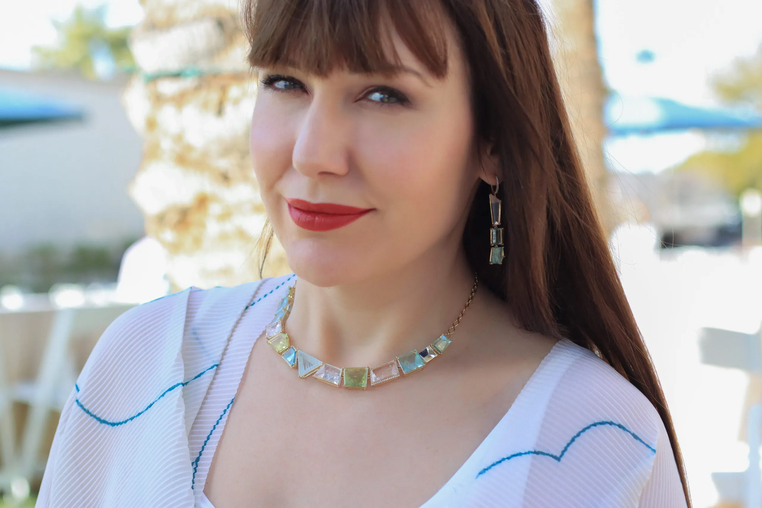 Katerina Perez wears a necklace and matching earrings from the Lisa Nik Sparkling Mermaid collection with pastel coloured beryls