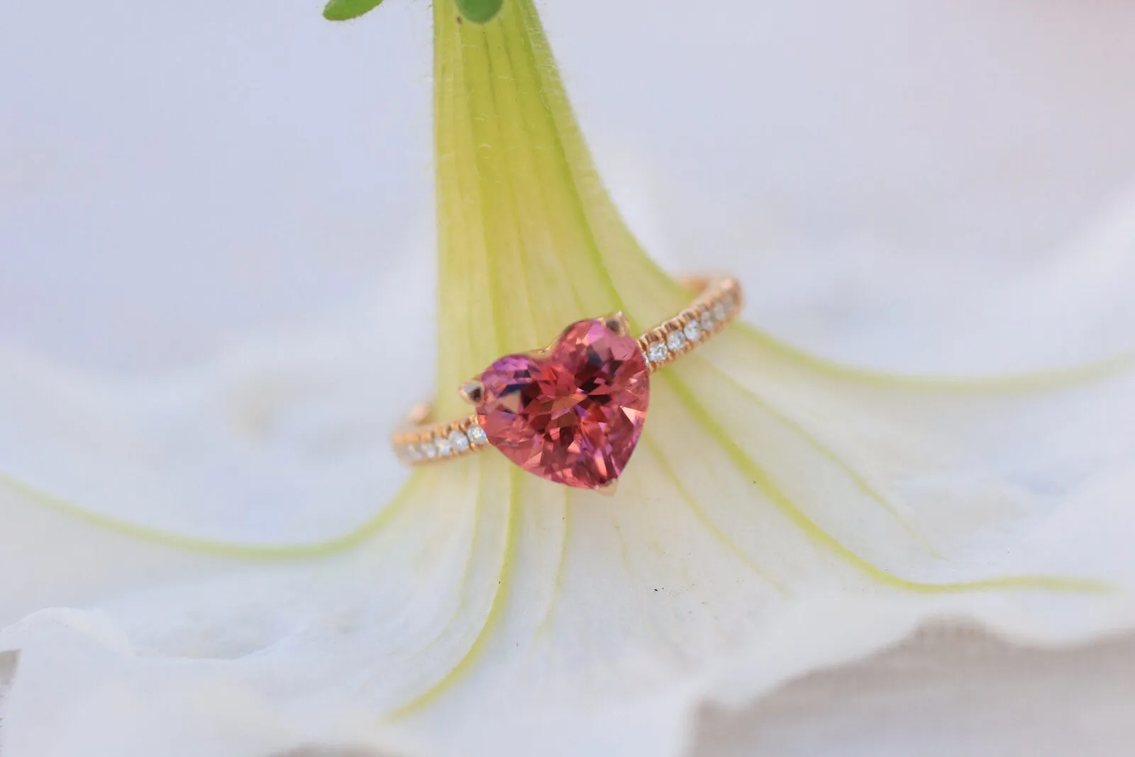 A heart-shaped pink tourmaline ring with diamond-set shoulders in 18k rose gold by Lisa Nik