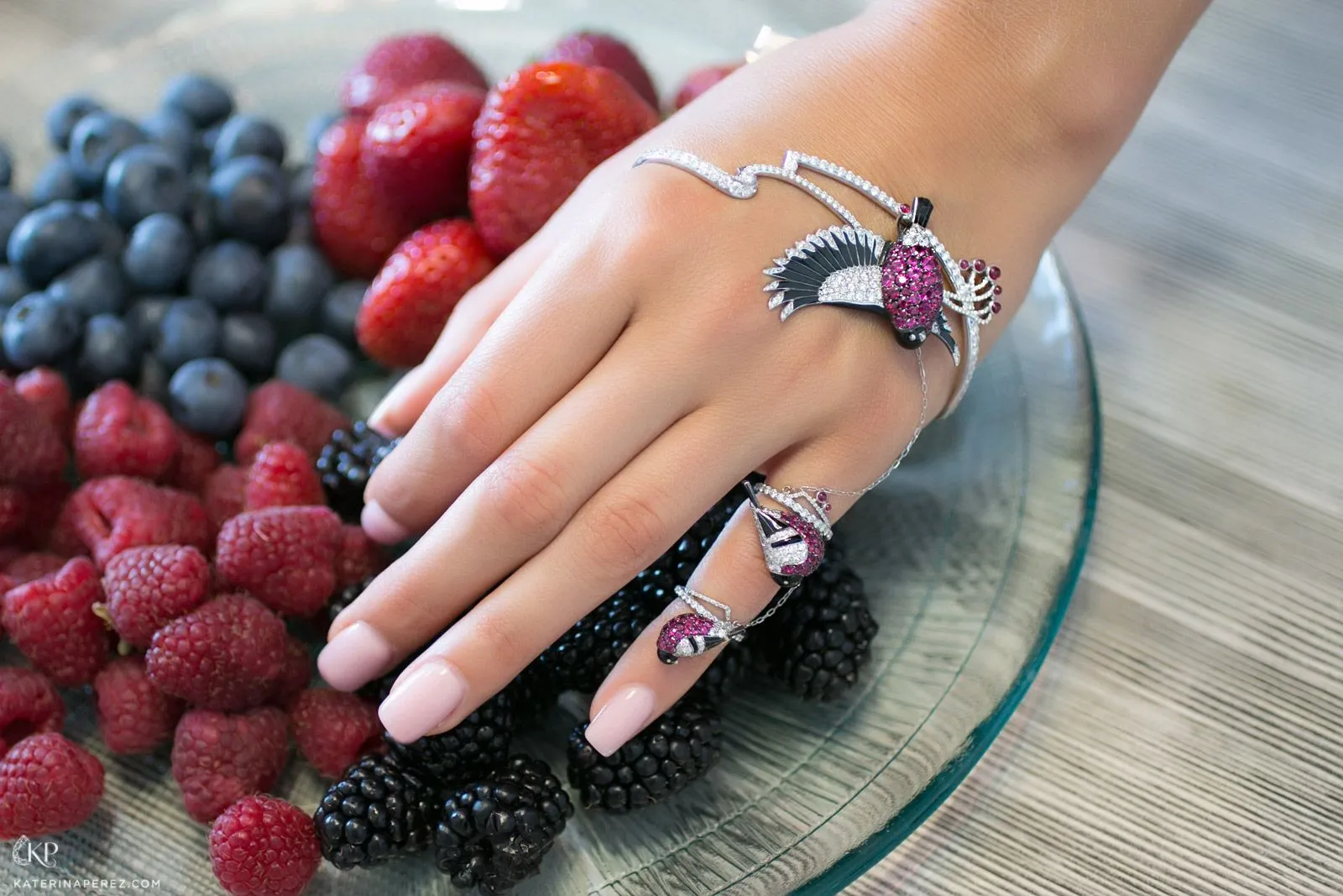 <p>A signature palm bracelet and attached ring with coloured gemstones and diamonds by Liza Borzaya</p>
