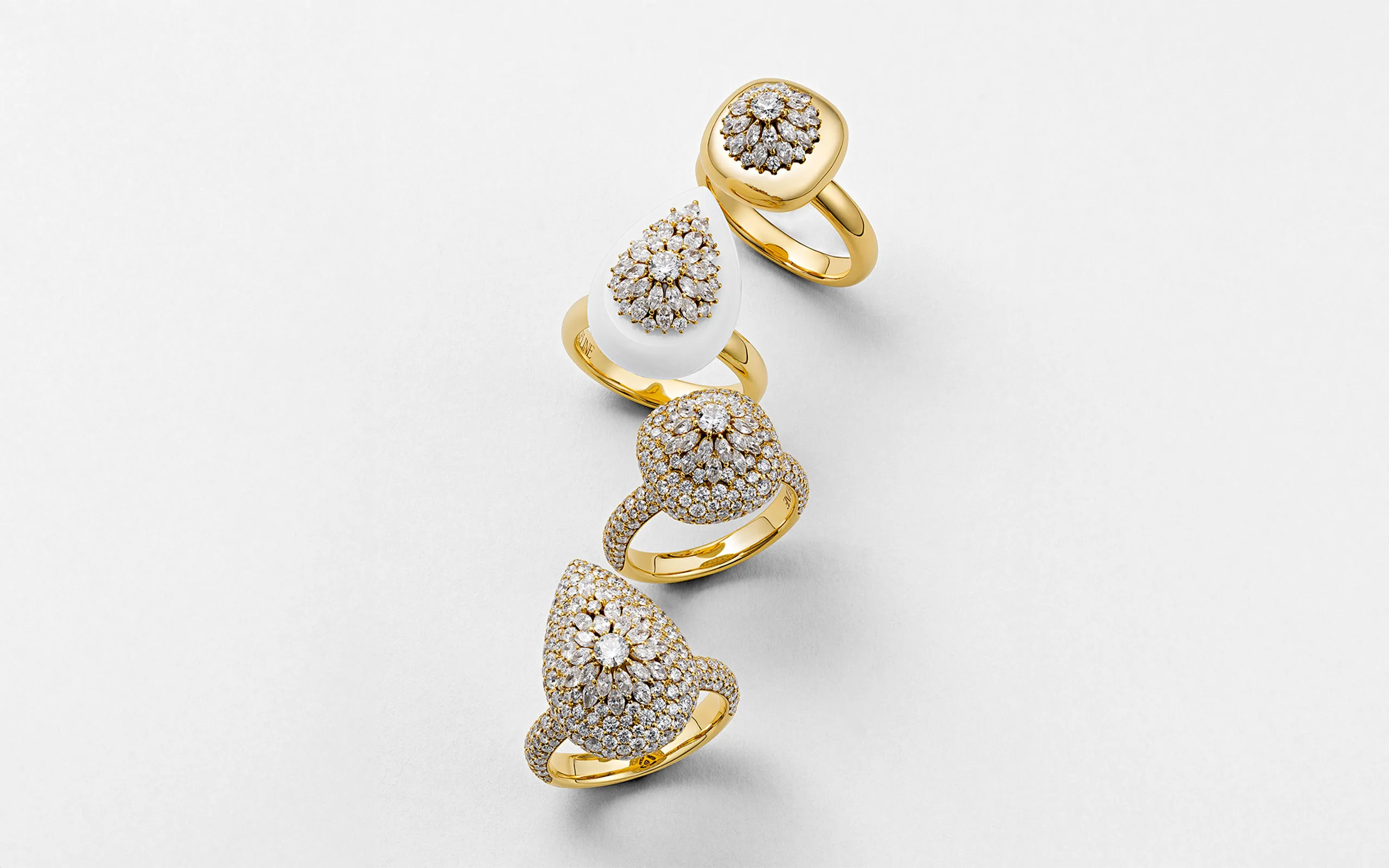 Marceline Paris Daisy rings from the Flower of Life collection, including a version with white ceramic (second from top) and the Pear-Shaped ring (bottom) with 3.76 carats of diamonds in 18k yellow gold 