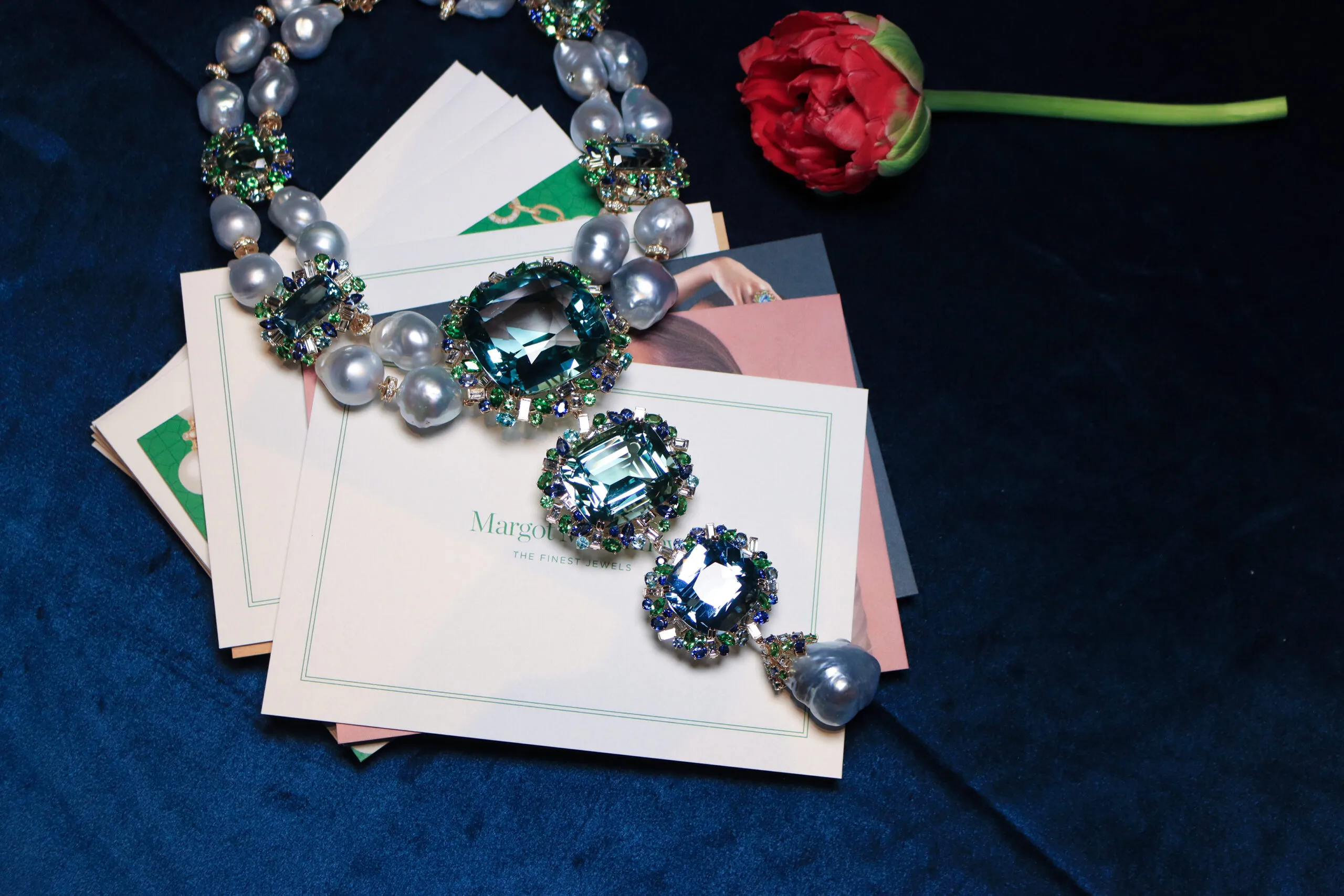 Margot McKinney Marina collier with an extraordinary suite of gemstones including two large green beryls (241.14ct and109.48ct) and an aquamarine (65.72ct) at its heart, along with 25 large Australian South Sea baroque pearls. The 24 pearls in the collier’s double strands measure17-22mm, while a single, particularly rare example measuring 26x30mm is placed as the focal point beneath the hero aquamarine. The piece is completed with two aquamarines (32.44ct), two green tourmalines (15.88ct and 24.09ct), and a green beryl (22.47ct) along with diamonds, sapphires, green tourmalines, Paraiba tourmalines, aquamarines and tsavorites, set in 18k yellow gold