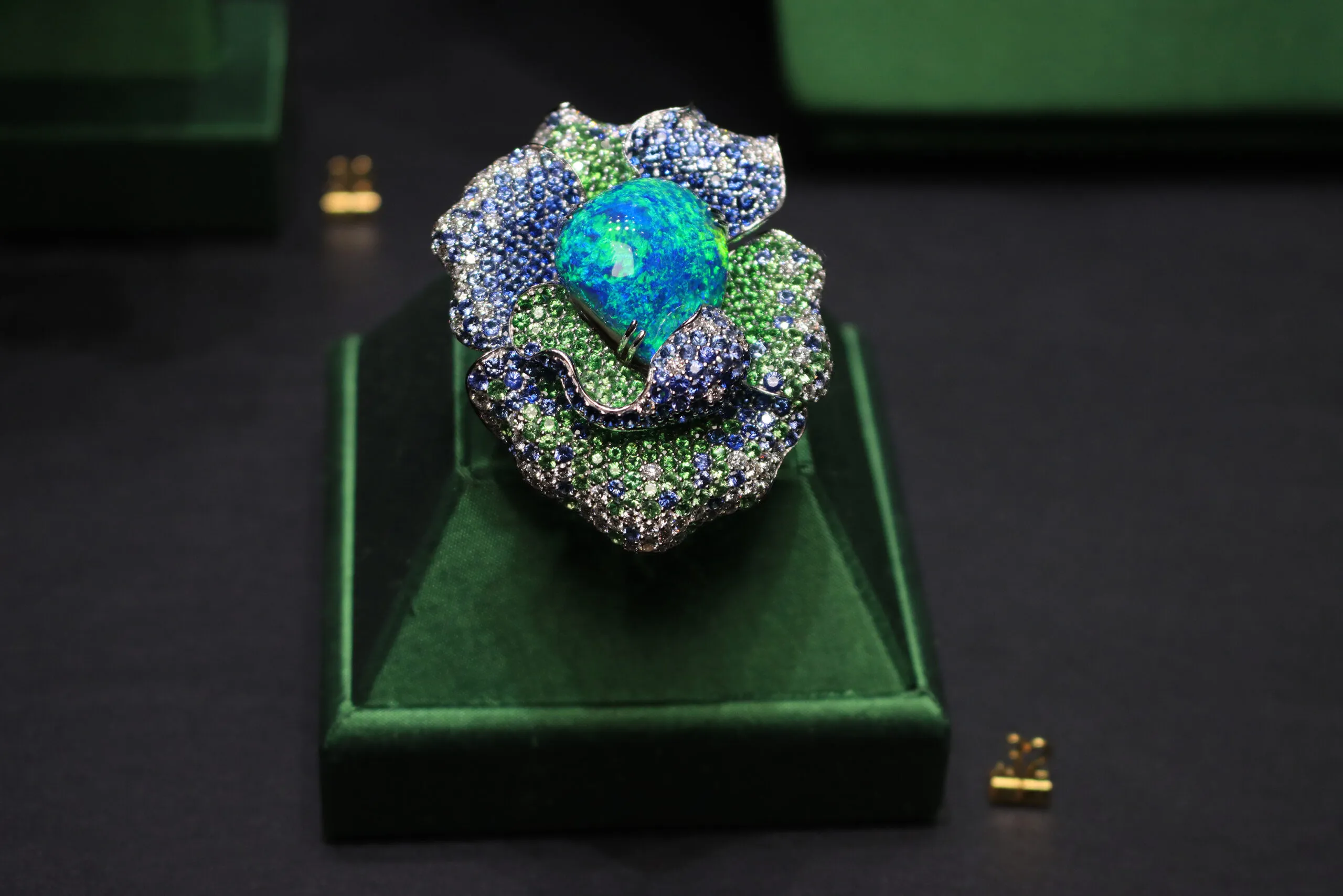 Margot McKinney Rainforest Bloom ring with a 37.52 carat Australian black opal, diamonds, blue sapphires and tsavorites, set in 18k white gold