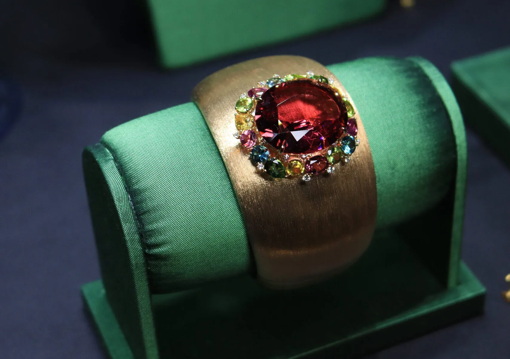 Margot McKinney Begonia cuff with a 32.97 carat rubellite, diamonds, yellow sapphires, green tourmalines, peridots, rhodolites and blue topazes set in 18k brushed yellow gold 