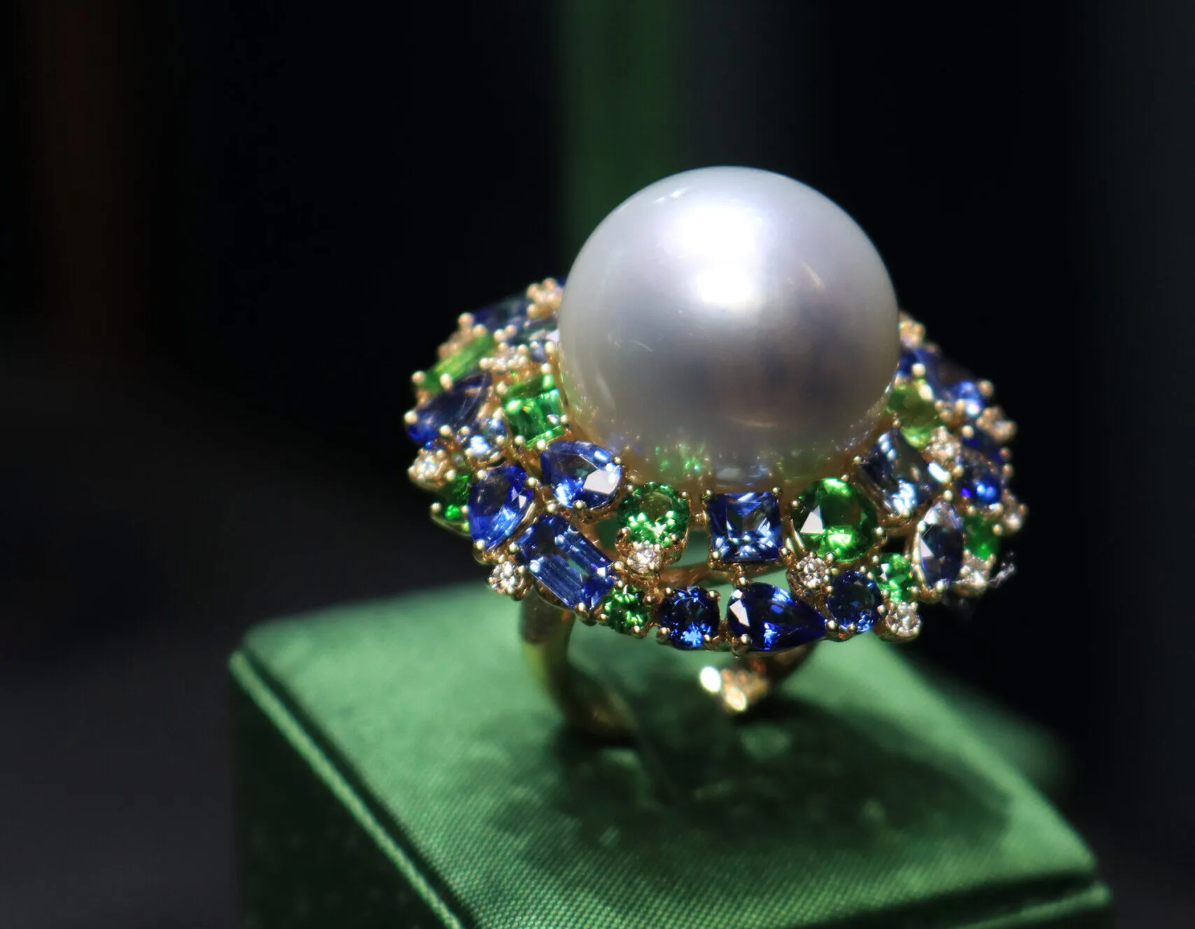 Margot McKinney Swirl ring with Australian South Sea pearls, diamonds, pink sapphires, purple sapphires, tsavorites and peridots set in 18k yellow and white gold