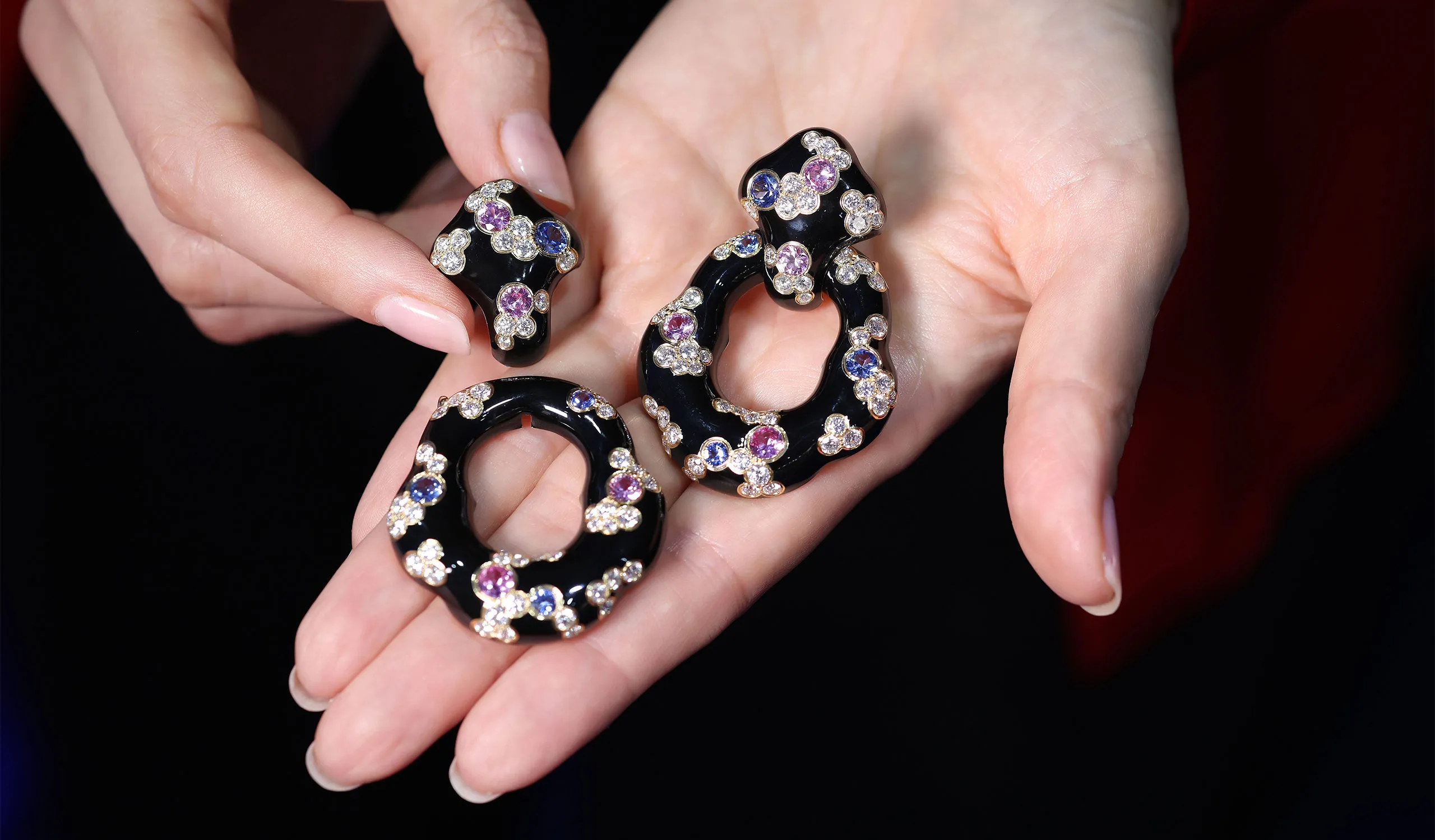 <p>The Fujiyama high jewellery earrings in glossy black enamel are dotted with diamonds and vivid pink and blue sapphires</p>
