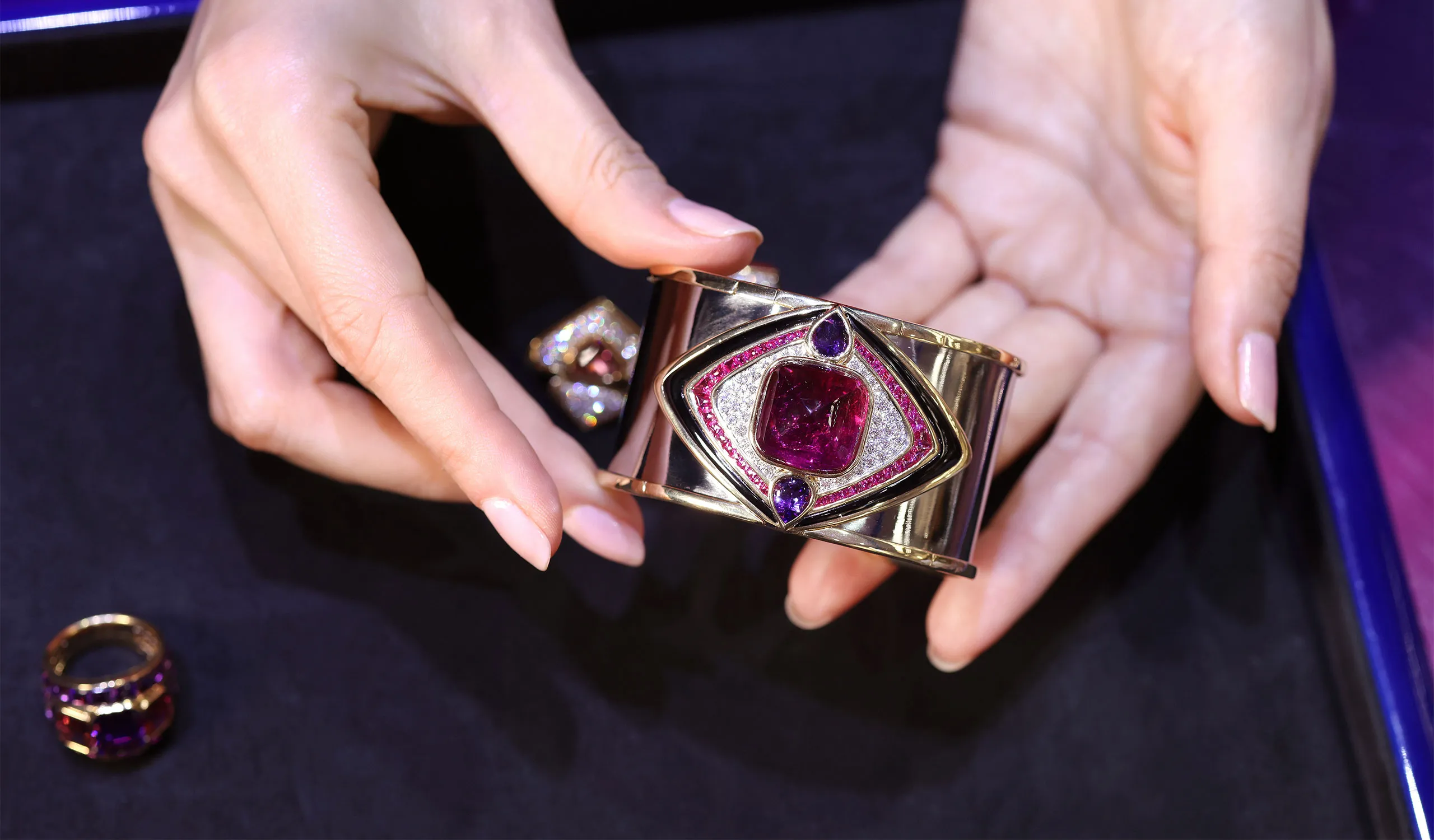 <p>The Marina B Sabina high jewellery cuff with a 29.64ct cabochon rubellite, 3.65ct onyx, 2ct pear shaped amethysts, 3.14ct buff top pink sapphires and pavé diamonds in 18k yellow gold </p>