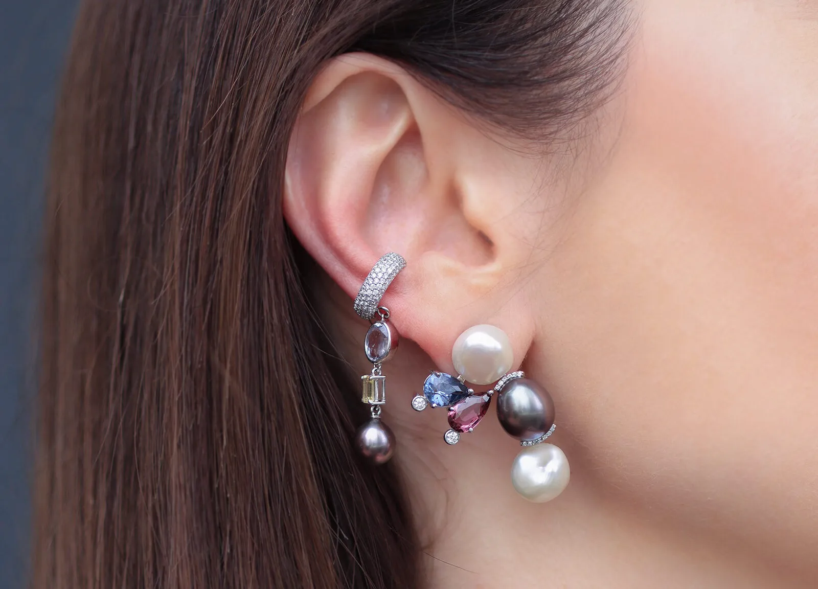 Mariyeh Ghelichkhani Bumble Bee earring from the Insect collection with a freshwater pearl, Tahitian pearl, purple and maroon spinels, and diamonds, pictured here alongside a diamond-set huggie and drop earring 