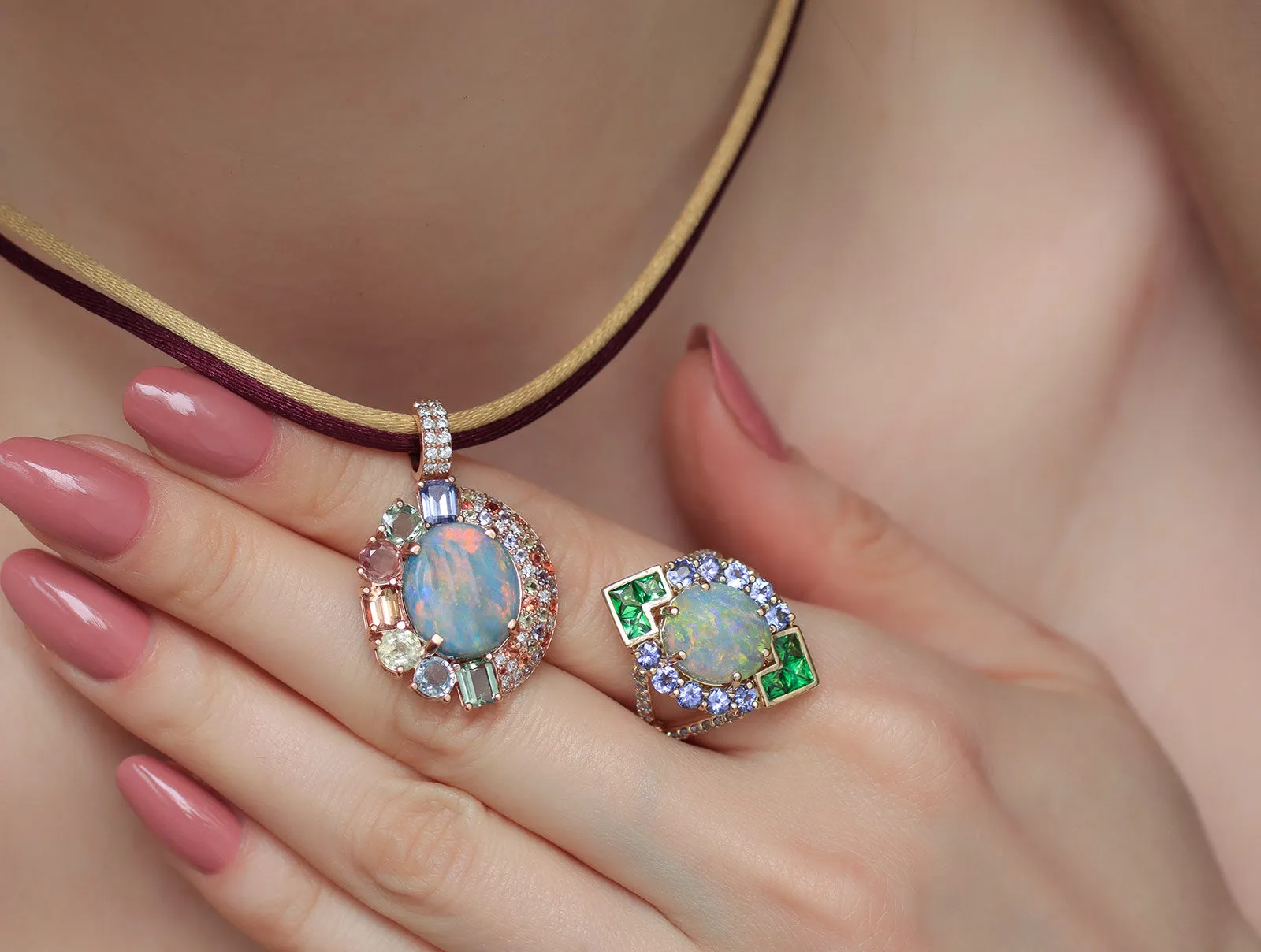 A closer look at the Mariyeh Ghelichkhani Twilight Splendour pendant with an Australian opal, sapphires, diamonds and tanzanite, and the Angels Fall ring with Australian opal, tsavorites and tanzanites, both in 18k yellow gold
